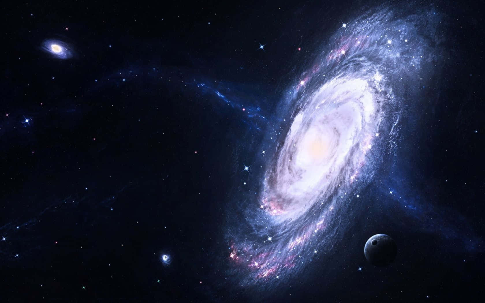 Real Galaxy 桌布 壁紙 — 一個宏偉的螺旋星系，帶有發光的旋臂和散落的星星，主宰著深邃的宇宙虛空，附近有一顆小行星。