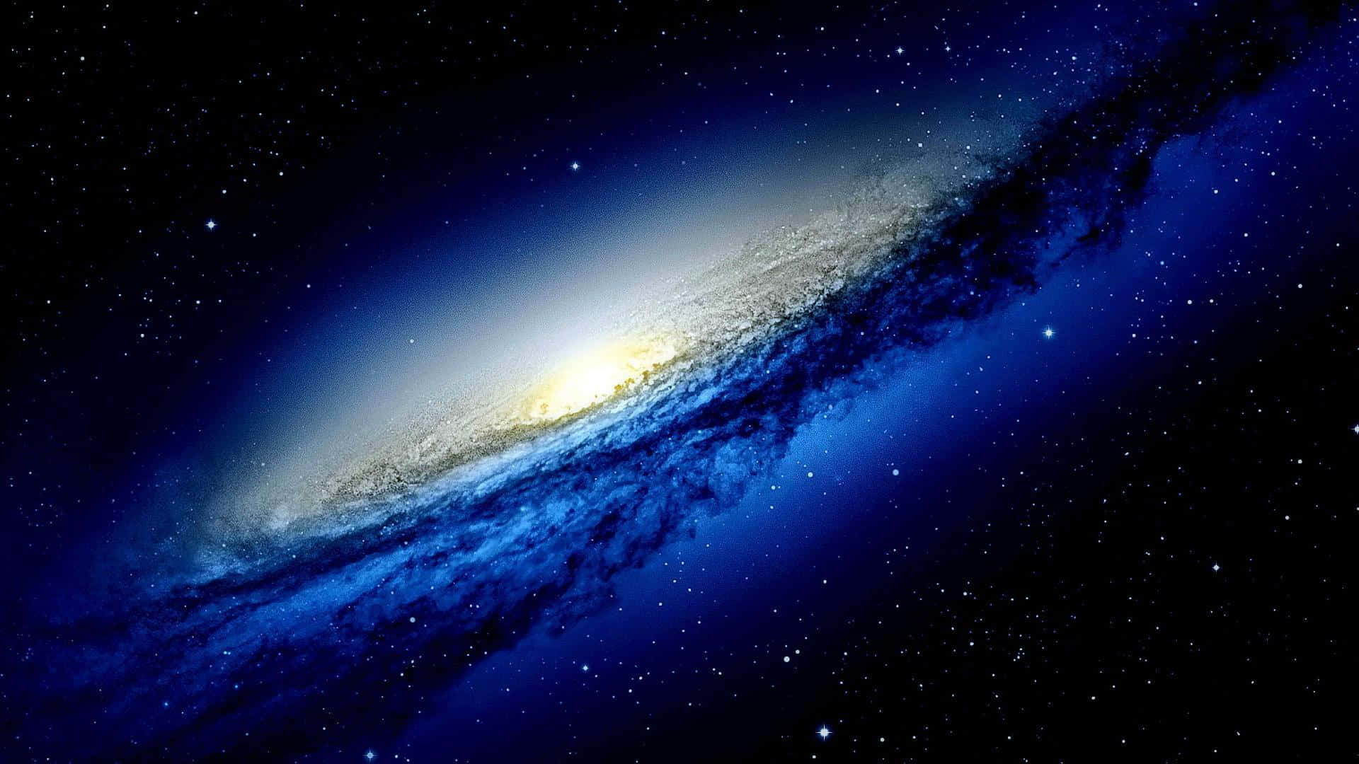 桌布 壁紙 — 一個宏偉的螺旋星系在深空的星場中發出藍色和金色的光芒。