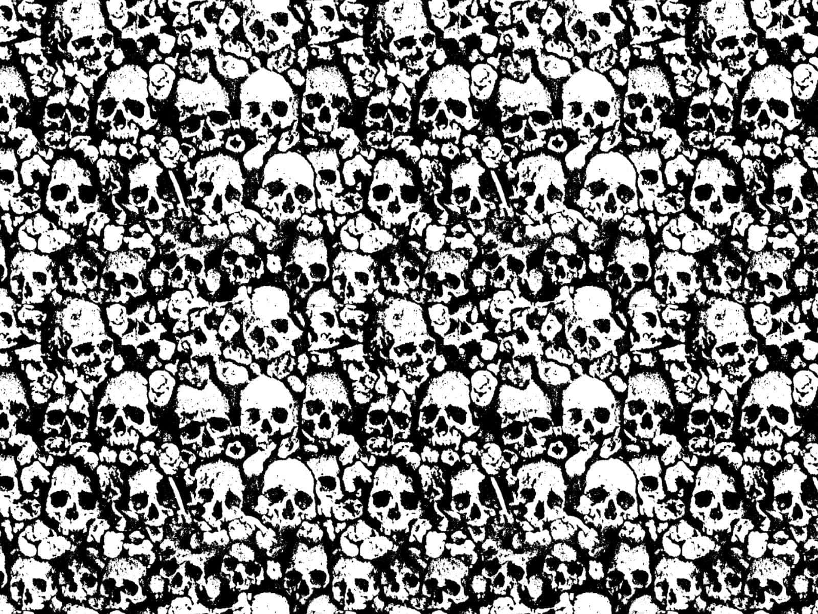 skulls 桌布 壁紙 — 一個密集的黑白圖案，由不同大小和角度的重疊頭骨組成，營造出混亂而詭異的視覺紋理。