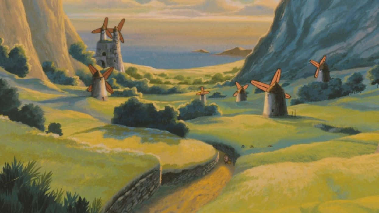 nausicaä of the valley of the wind 桌布 壁紙 — 一個寧靜的動畫山谷，金色夕陽天空下，綠色丘陵上點綴著石磨風車。
