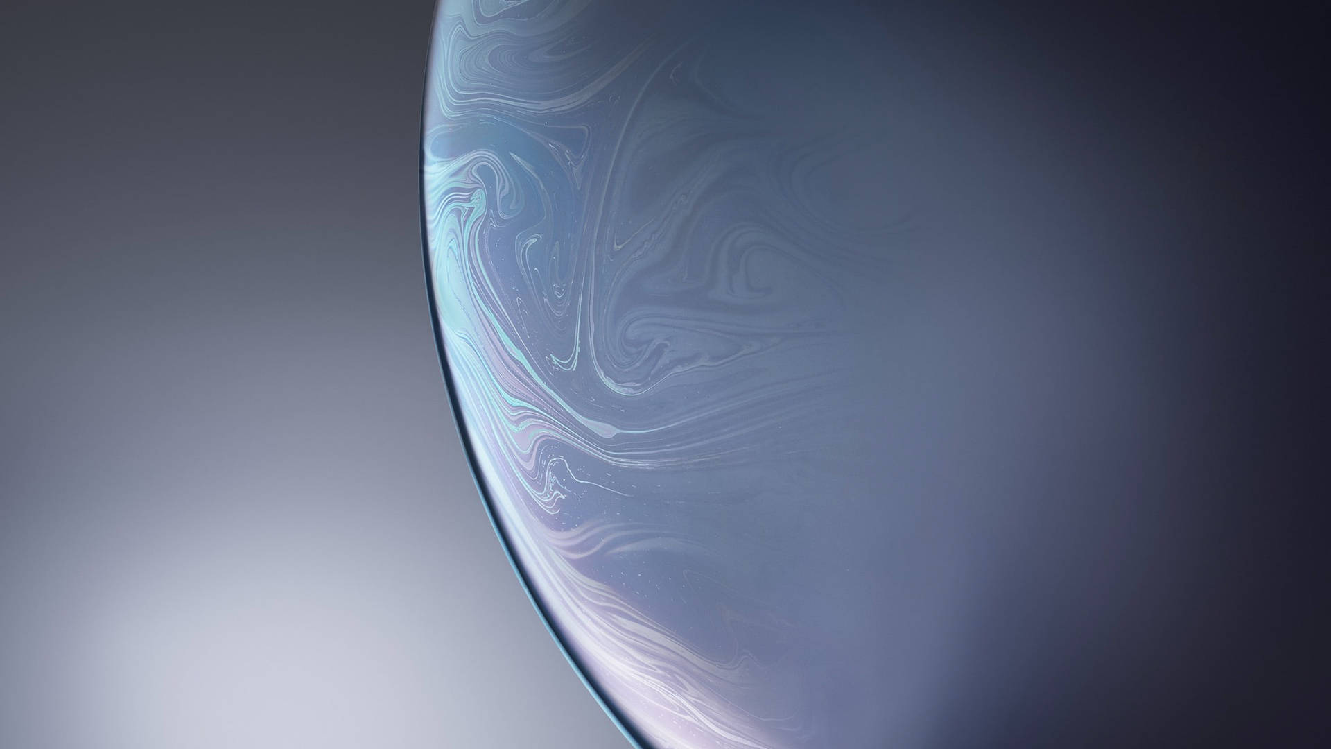 iPhone 12 stock 桌布 壁紙 — 一個寧靜的宇宙球體，帶有旋轉的藍色和白色星雲圖案，在漸變灰色背景上柔和地發光。