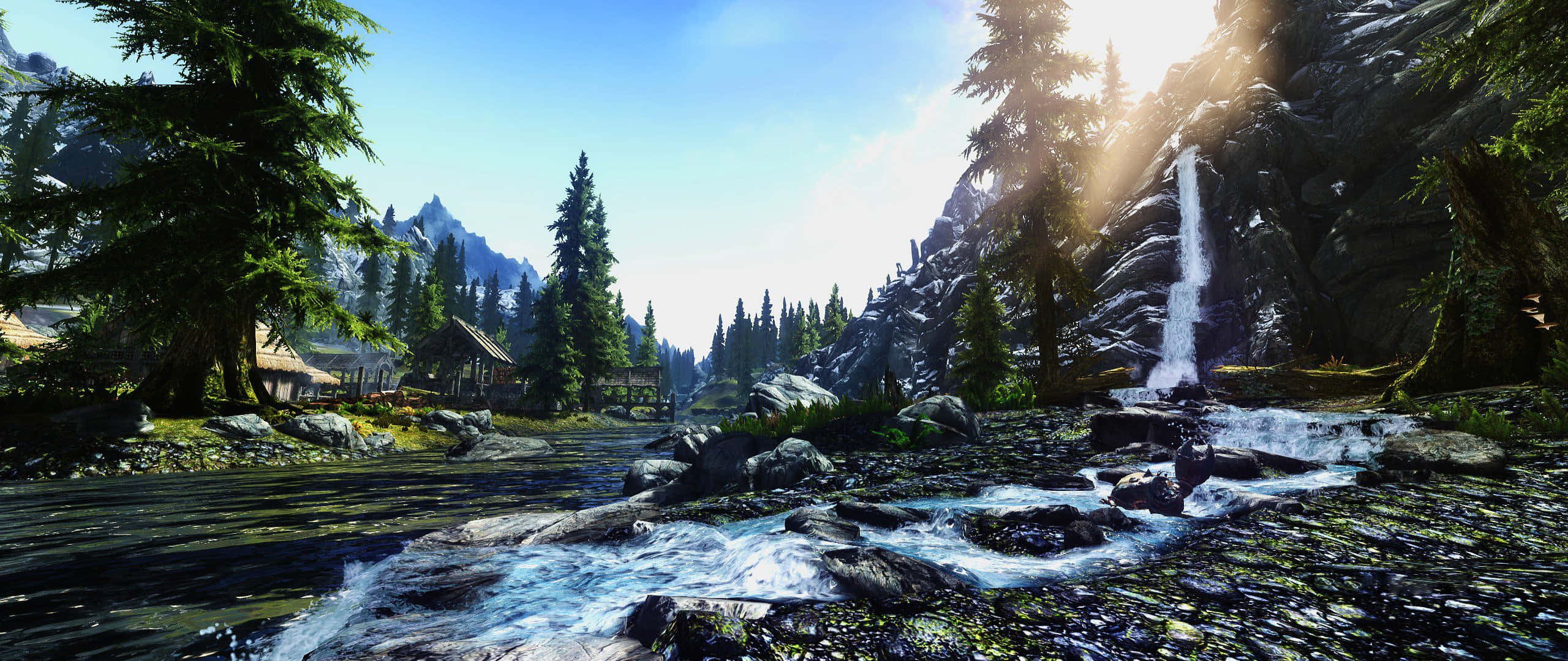 Skyrim Landscapes 桌布 壁紙 — 一個寧靜的山谷，有湍急的河流流過長滿苔蘚的岩石，以及從岩石懸崖傾瀉而下的瀑布。