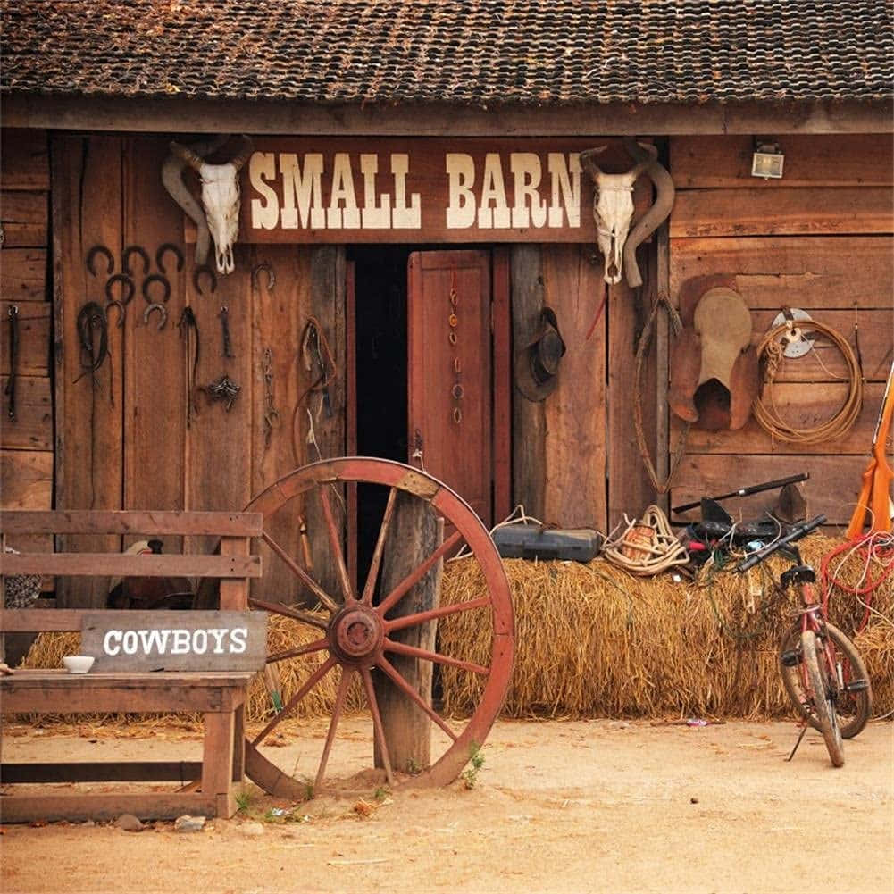木紋 桌布 壁紙 — 一個寫有「SMALL BARN」的鄉村木製穀倉，前面有牛頭骨、角、馬蹄鐵和一個紅色馬車輪。