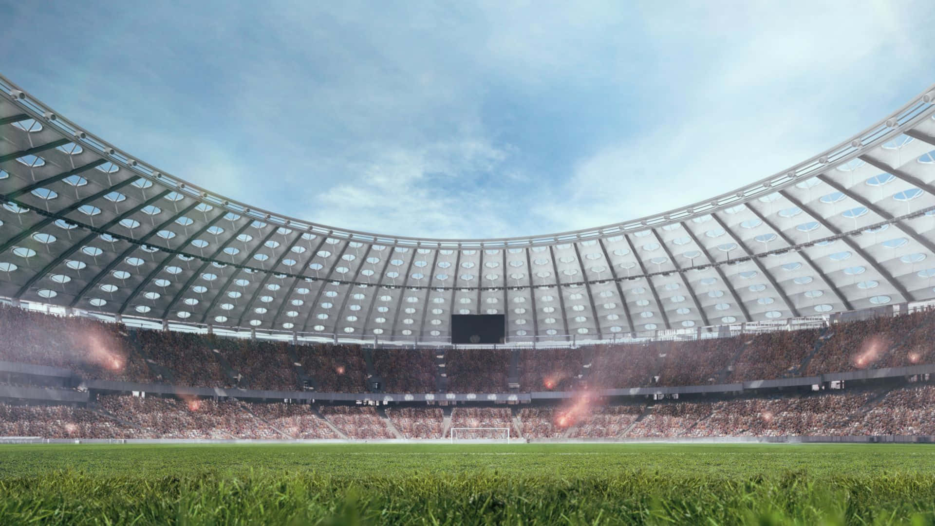 Soccer Stadium 桌布 壁紙 — 一個寬敞的現代體育場，在晴朗的藍天和蓬鬆的白雲下，擠滿了歡呼的球迷。