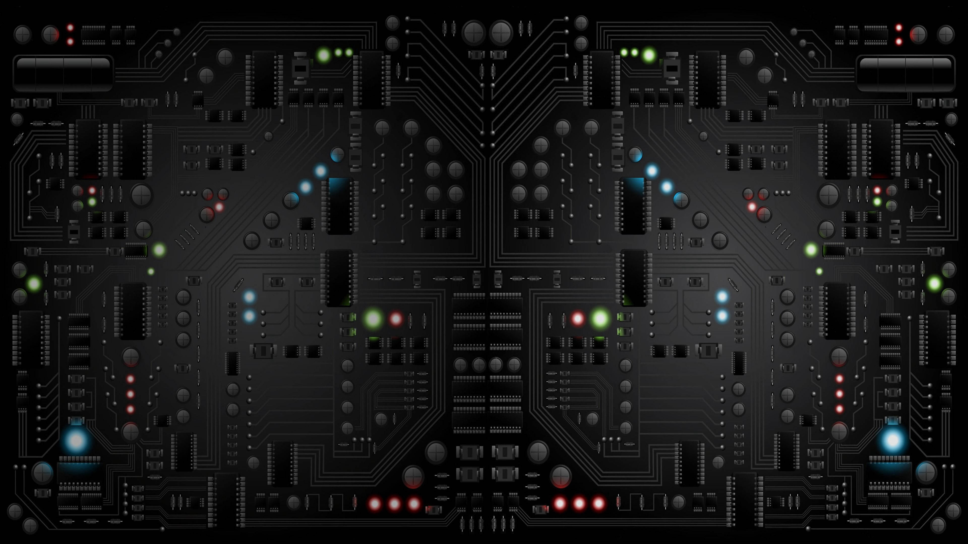 Processor 桌布 壁紙 — 一個對稱的黑色電路板，帶有發光的綠色、藍色和紅色LED，形成未來數位圖案。