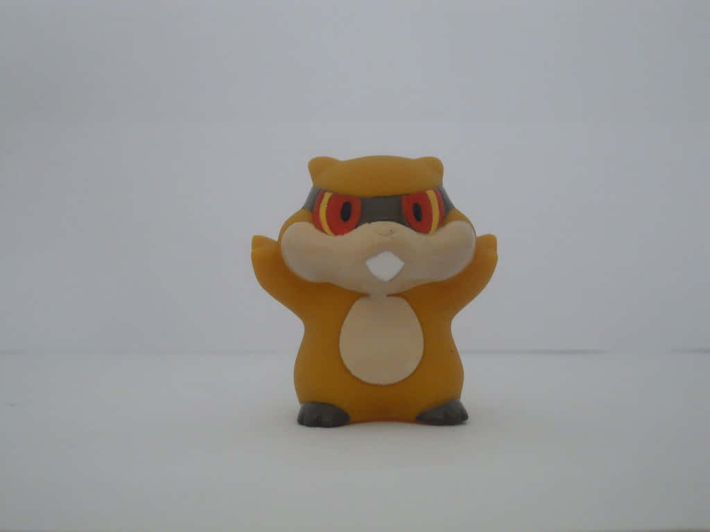 Pokemon Aesthetic 桌布 壁紙 — 一個小型橙色毛絨玩具，有紅色眼睛和黑色護目鏡，站在純白色表面上。