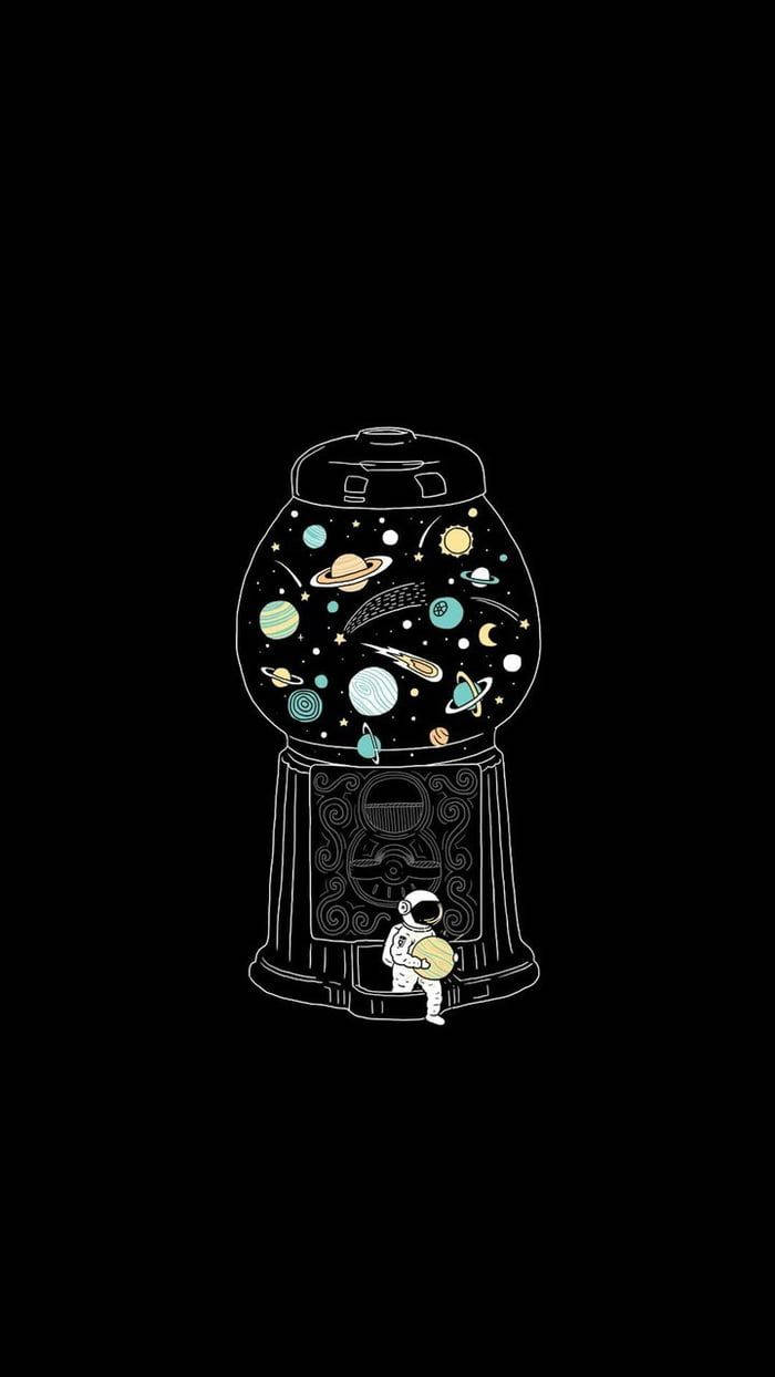  壁紙 — 一個小太空人坐在一個裝滿彩色行星和星星的扭蛋機前，背景為黑色。