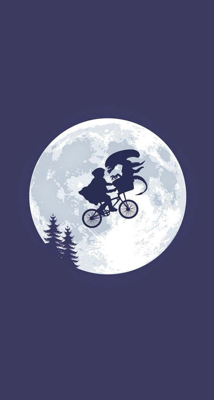 Et 桌布 壁紙 — 一個小孩和外星人騎腳踏車的剪影，背景是一個巨大的月亮，下方有松樹。