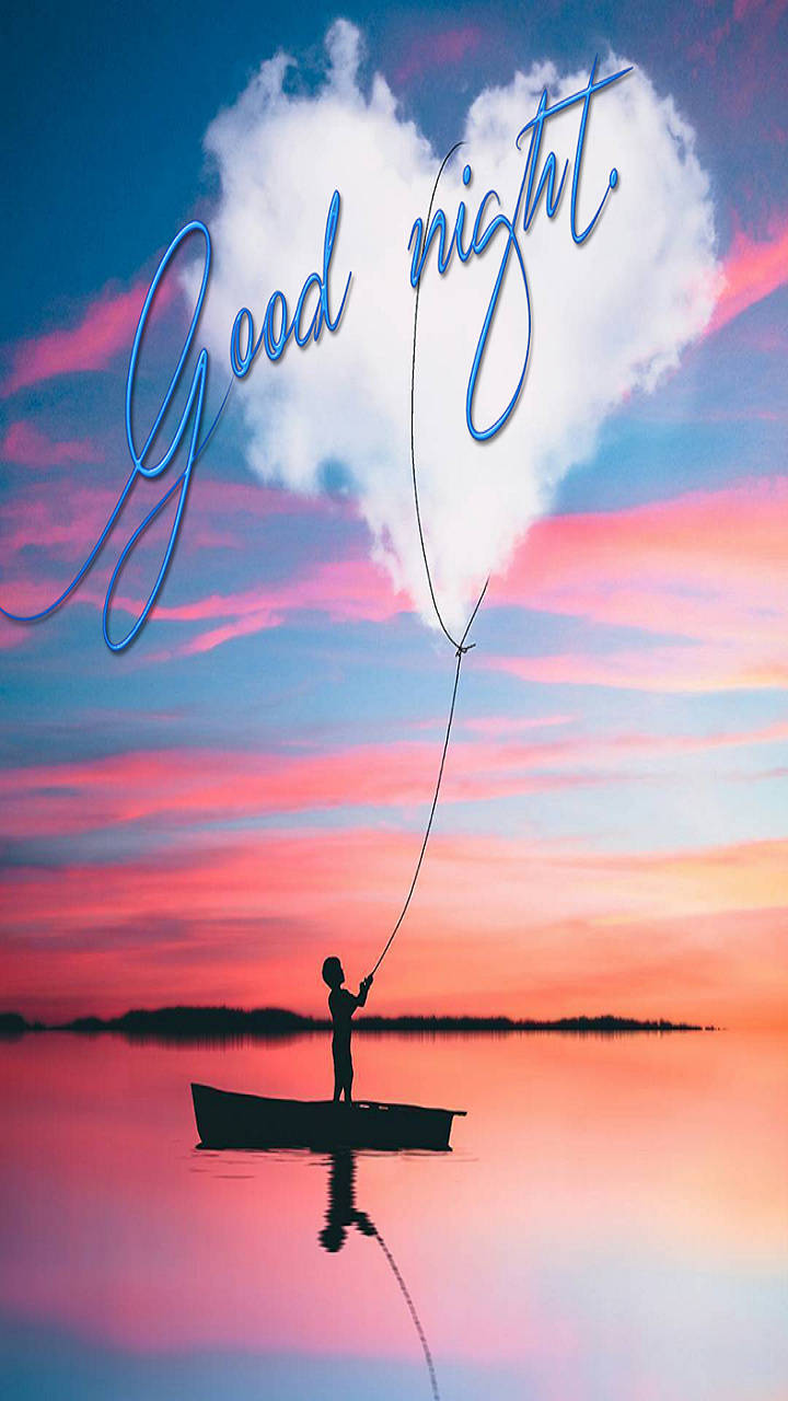 Good Night 桌布 壁紙 — 一個小孩在船上拉著一朵心形雲，雲上以草書寫著good night，背景是充滿活力的日落天空。