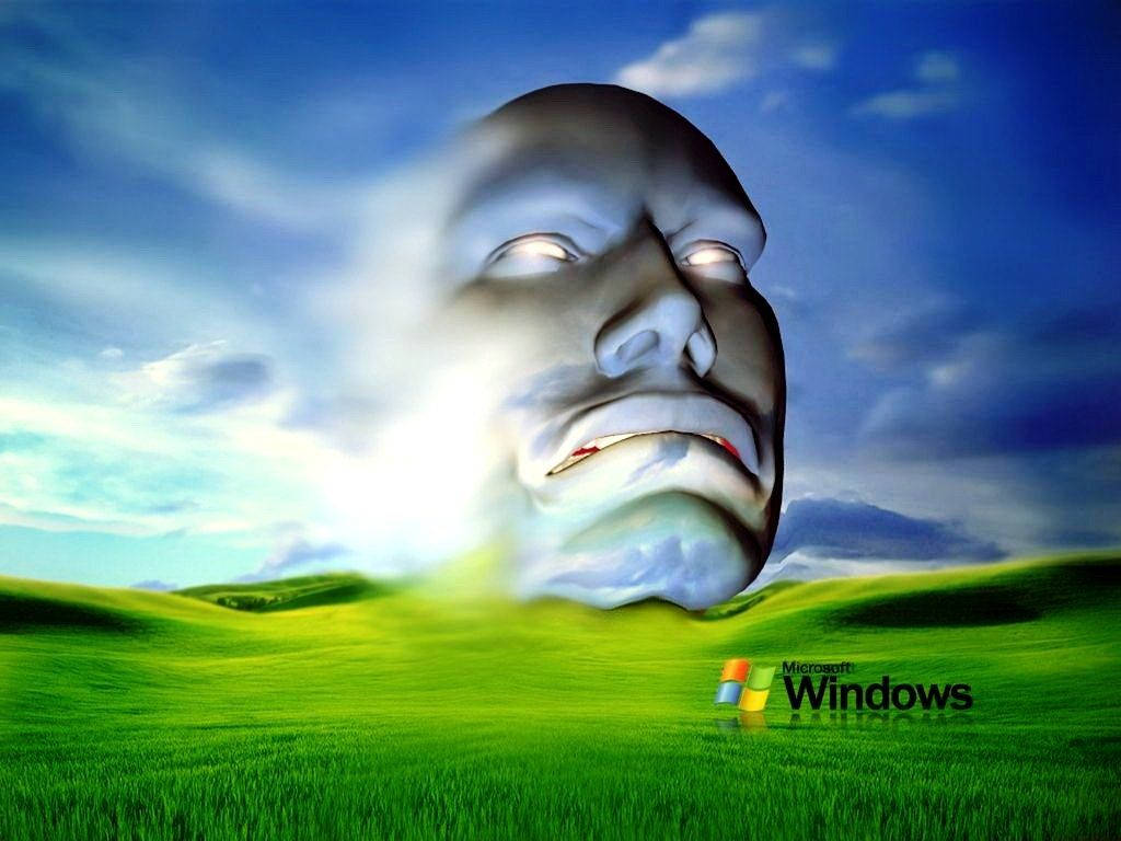 Xp 桌布 壁紙 — 一個巨大的寧靜面孔從充滿活力的綠色田野中浮現，背景是藍天和蓬鬆的白雲。