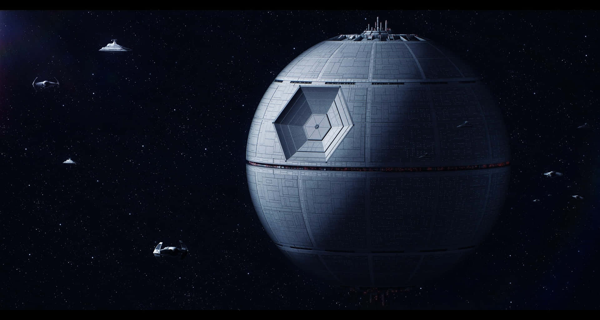 Death Star Ii 桌布 壁紙 — 一個巨大的球形死星主宰著一個佈滿星星的虛空，較小的星際戰機在其表面軌道上運行。