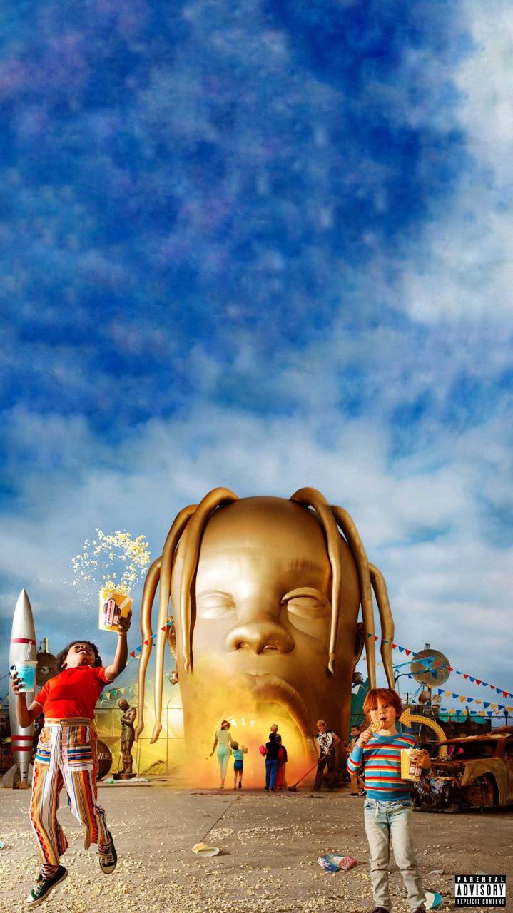Astroworld 桌布 壁紙 — 一個巨大的金色嬰兒頭像雕塑，帶有辮子，籠罩著在鮮豔藍天下玩火箭和爆米花的孩子們。