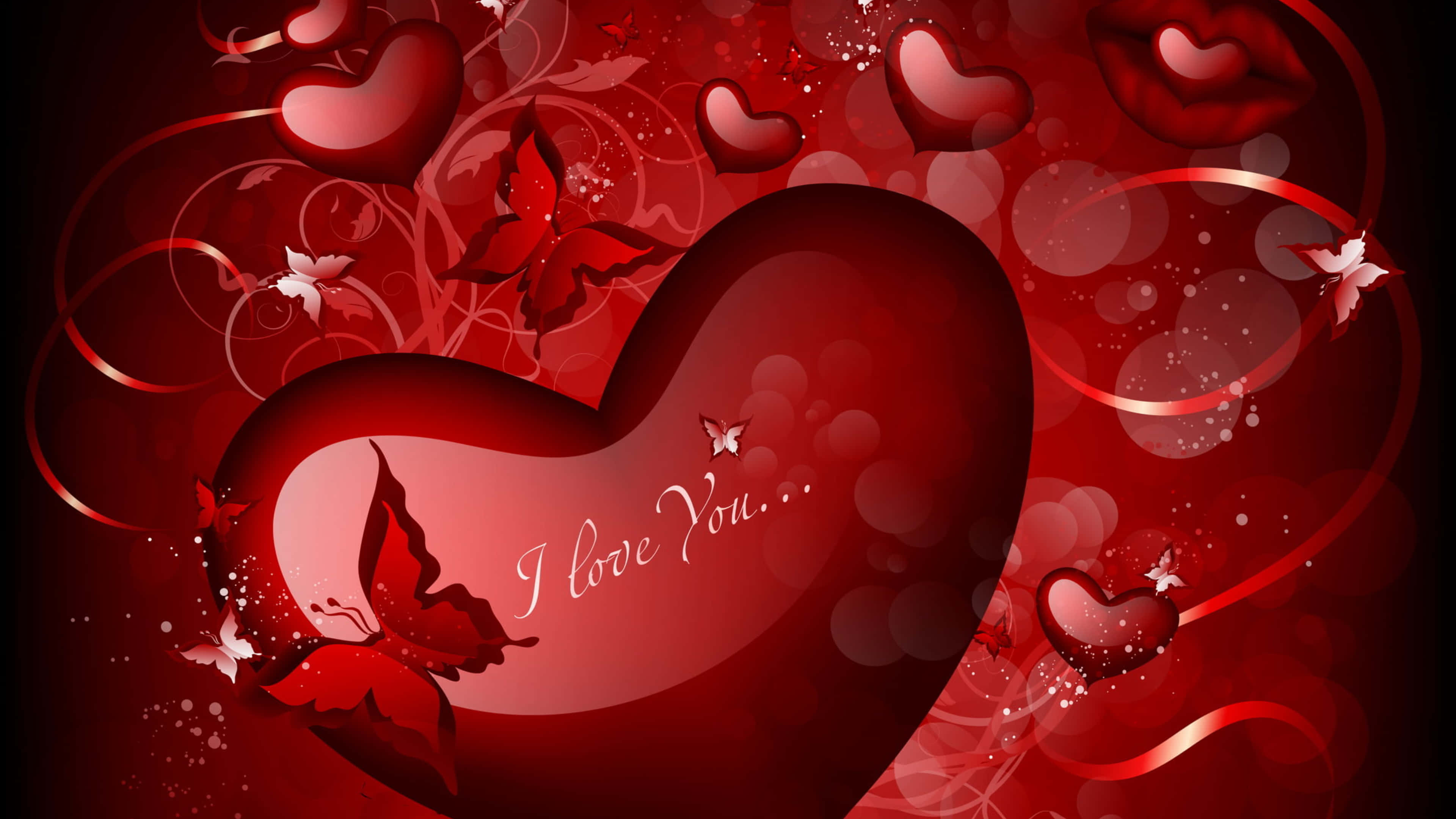 4K Love 桌布 壁紙 — 一個帶有 'I love you' 文字的亮面紅色愛心，被旋轉的絲帶、蝴蝶和較小的愛心環繞，背景是深紅色的散景。