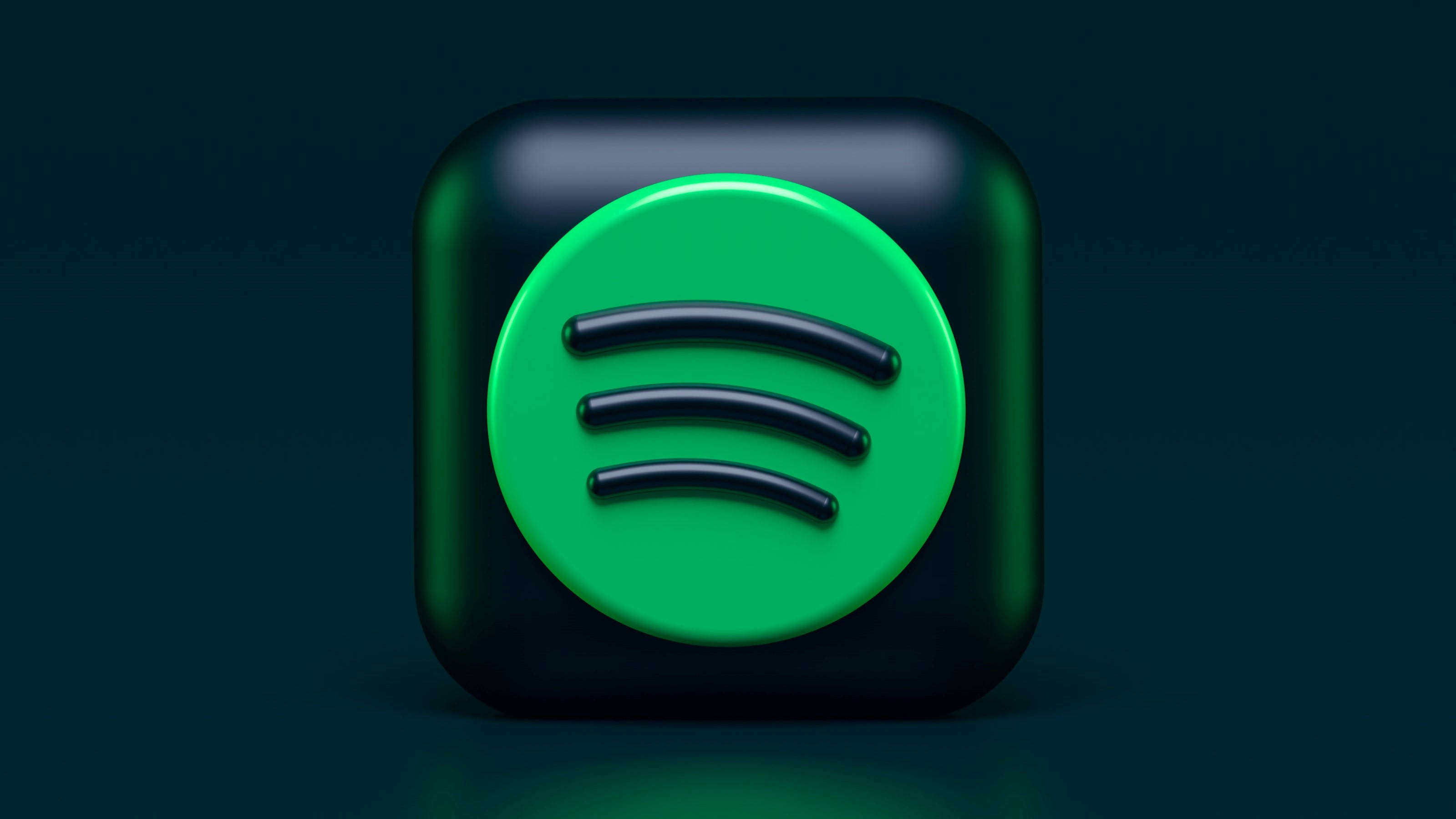 Spotify 桌布 壁紙 — 一個帶有光澤的 3D 渲染 Spotify 應用程式圖標，中央有一個充滿活力的綠色圓圈和黑色聲波線條，背景為深青色。