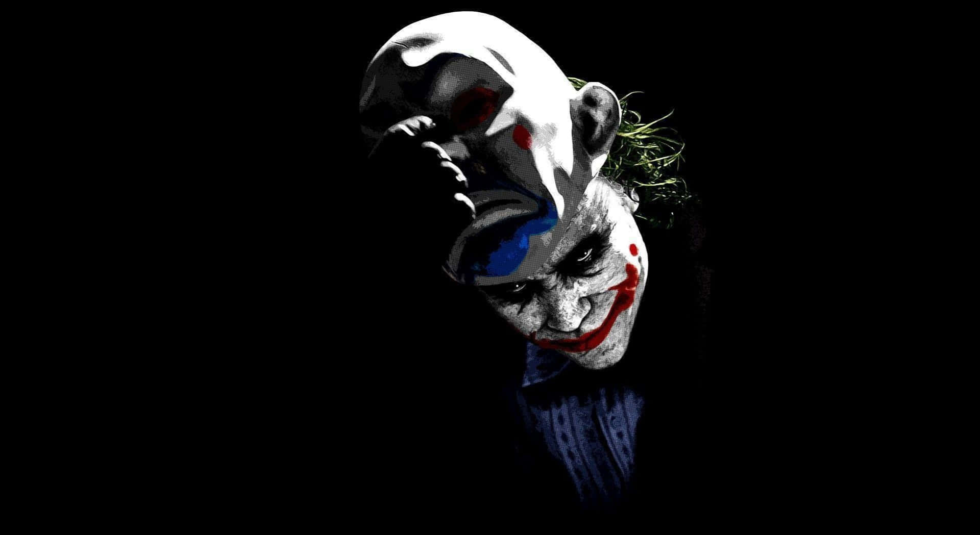 Cool Scary 桌布 壁紙 — 一個帶有塗抹化妝和狂野頭髮的威脅性小丑，在黑色背景下強烈凝視。