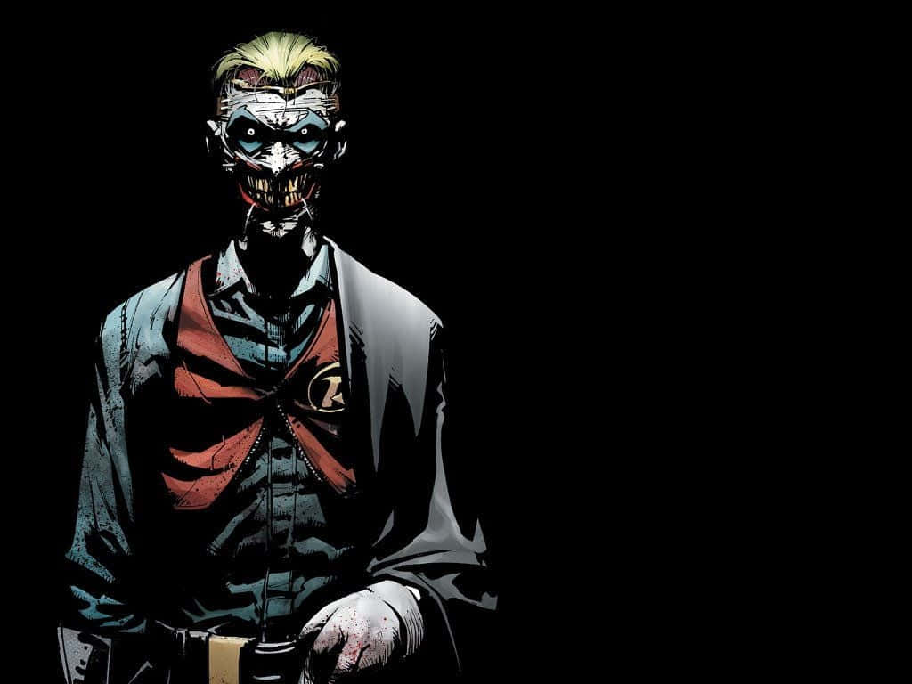 Batman Death In The Family 桌布 壁紙 — 一個帶有塗鴉笑容和尖刺金髮的威脅性漫畫反派站在黑色背景前。