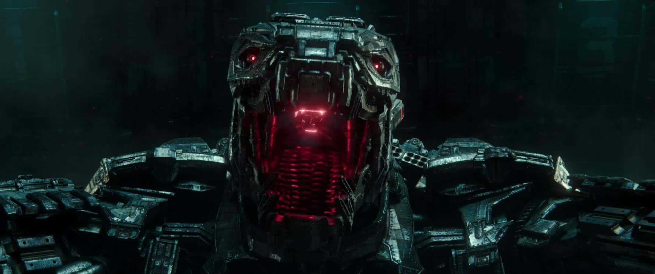 Robot Godzilla 桌布 壁紙 — 一個帶有發光紅眼和嘴巴的威脅性機械捕食者潛伏在黑暗的工業環境中。