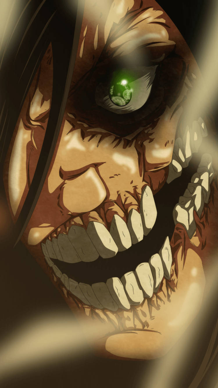 Attack On Titan iPhone 桌布 壁紙 — 一個帶有發光綠色眼睛和尖銳牙齒的威脅性動畫巨人，在特寫鏡頭中強烈凝視。