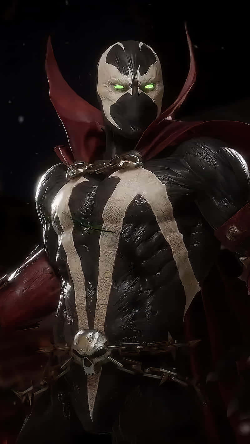 Mortal Kombat 11 Spawn 桌布 壁紙 — 一個帶有發光綠色眼睛和紅色斗篷的威脅性蒙面戰士，站在黑暗的星空背景前。