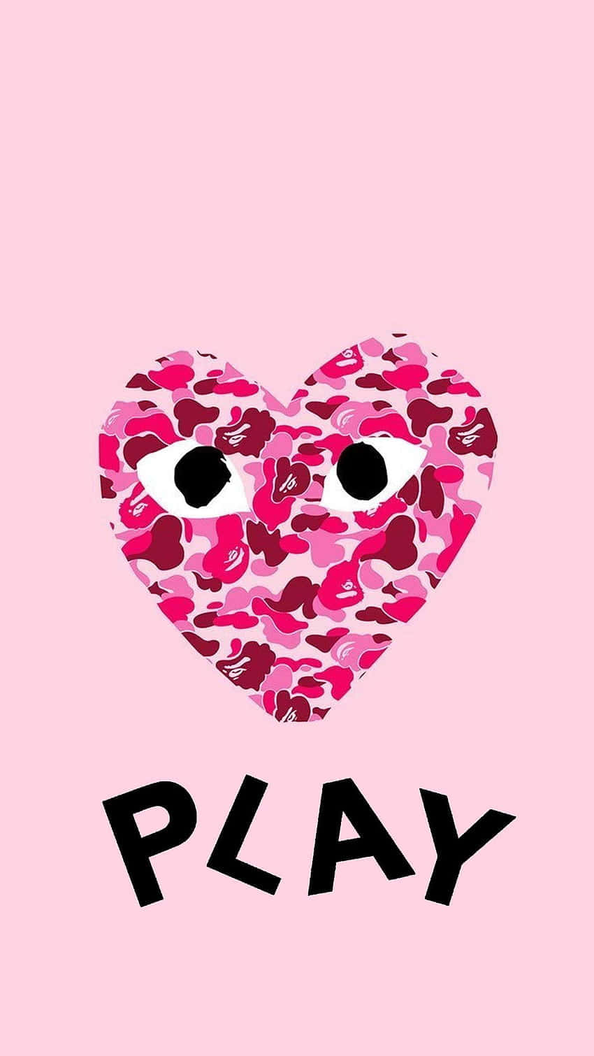 Heart 桌布 壁紙 — 一個帶有眼睛的粉紅色迷彩心形，以及「PLAY」字樣，位於柔和的粉紅色背景上。