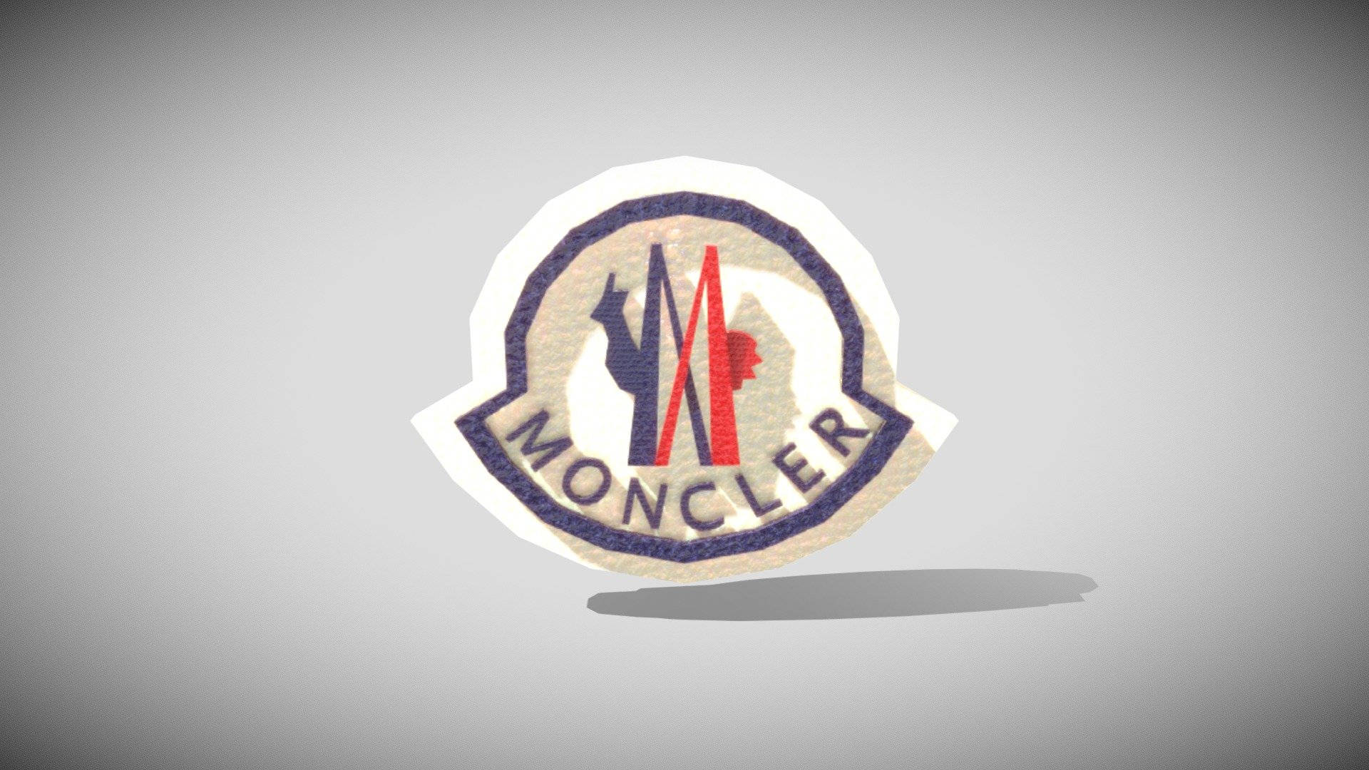 Moncler 桌布 壁紙 — 一個帶有紅色、藍色和米色色調的紋理Moncler標誌補丁漂浮在柔和的灰色漸變背景上。
