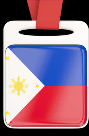 Flag Of The Philippines 桌布 壁紙 — 一個帶有紅色絲帶的光澤菲律賓國旗裝飾品，掛在白色標籤上，背景為黑色。