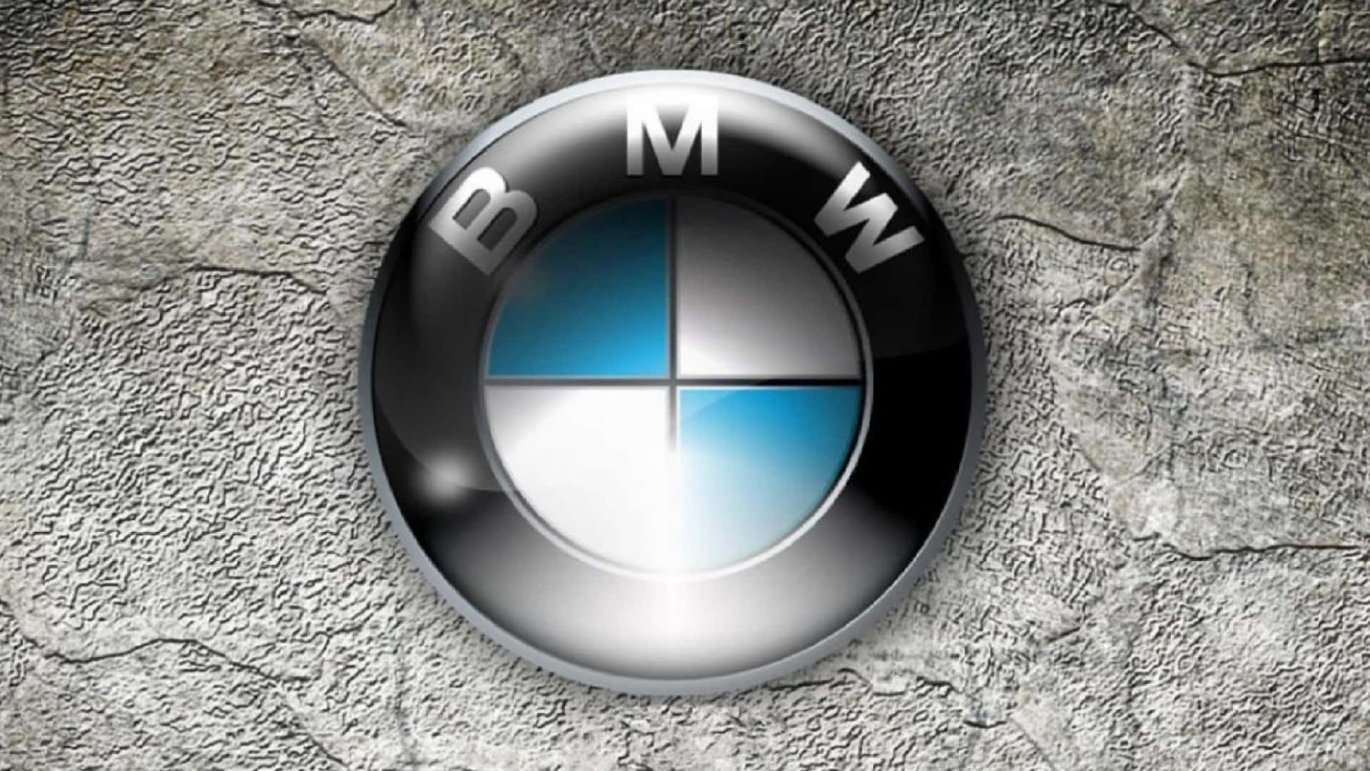 Bmw Logo 桌布 壁紙 — 一個帶有藍色和白色象限的光面BMW標誌位於粗糙的灰色混凝土牆中央。