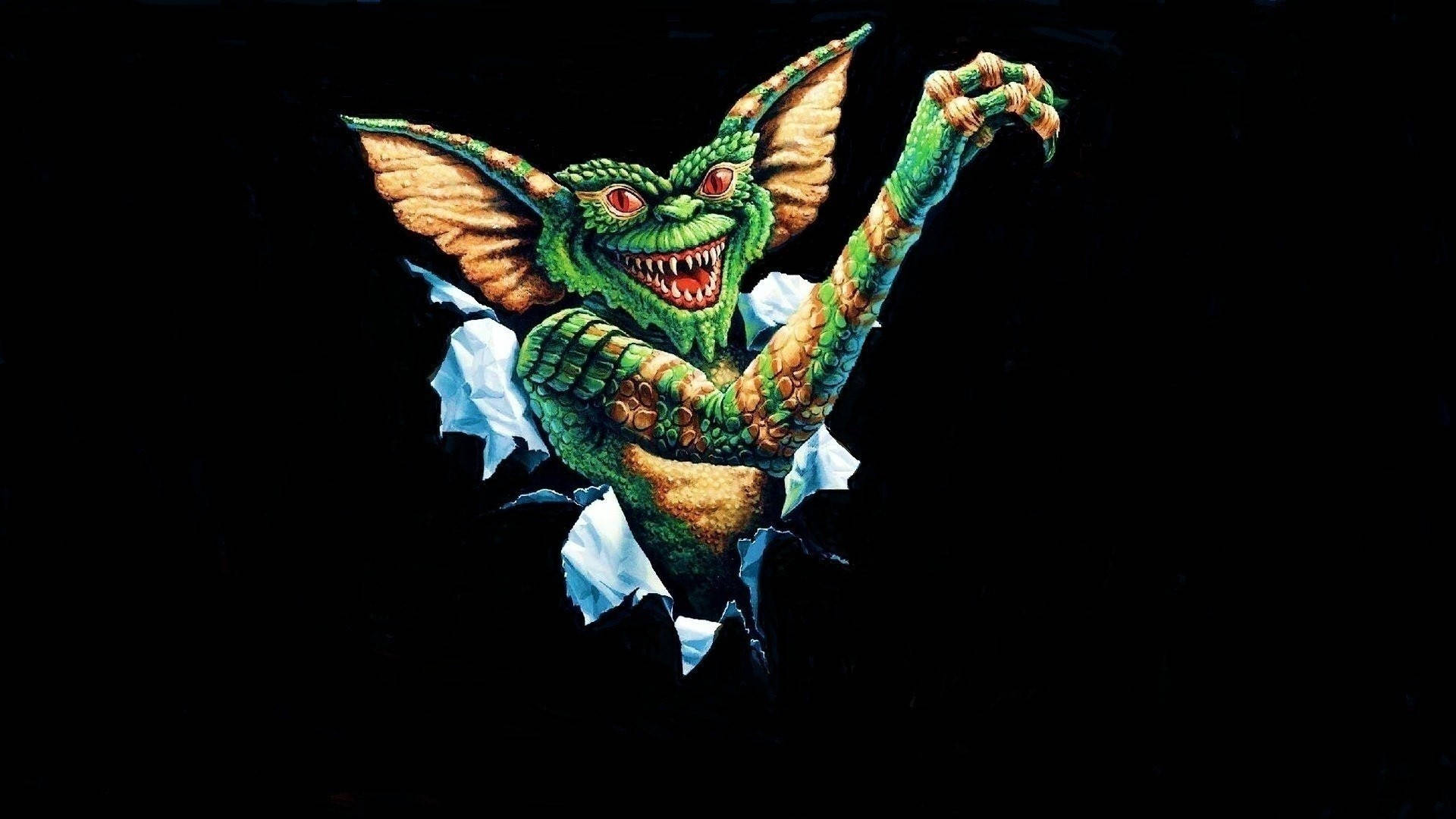 Gremlins 桌布 壁紙 — 一個帶有蝙蝠翅膀和尖銳牙齒的綠色哥布林，在黑色背景上撕破白色表面衝出來。