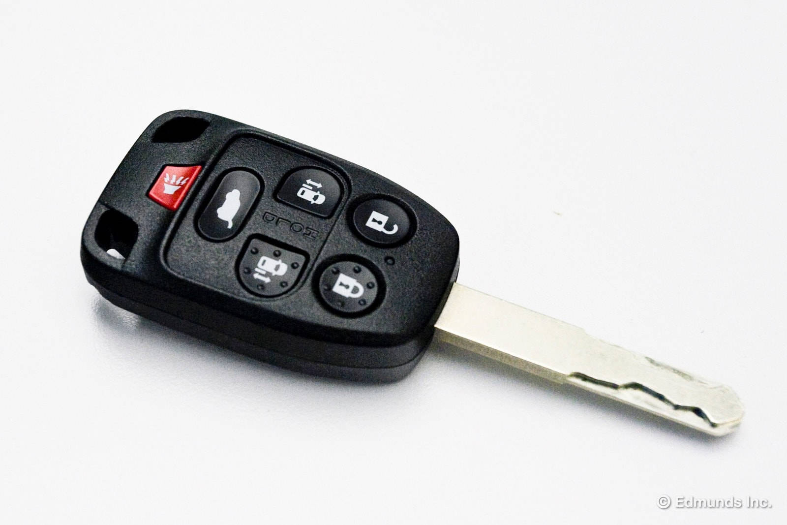 key 桌布 壁紙 — 一個帶有金屬鑰匙片的黑色車鑰匙遙控器，放在白色平面上。