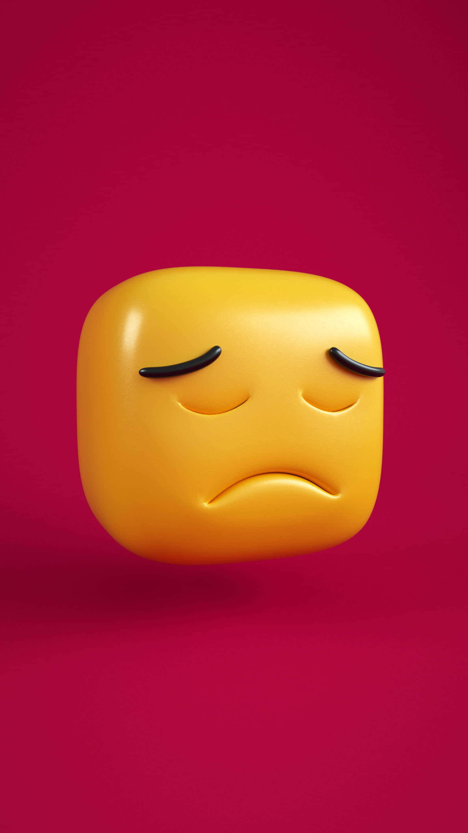 Sad Face 桌布 壁紙 — 一個帶有閉眼的光澤黃色悲傷表情符號漂浮在充滿活力的洋紅色背景上。