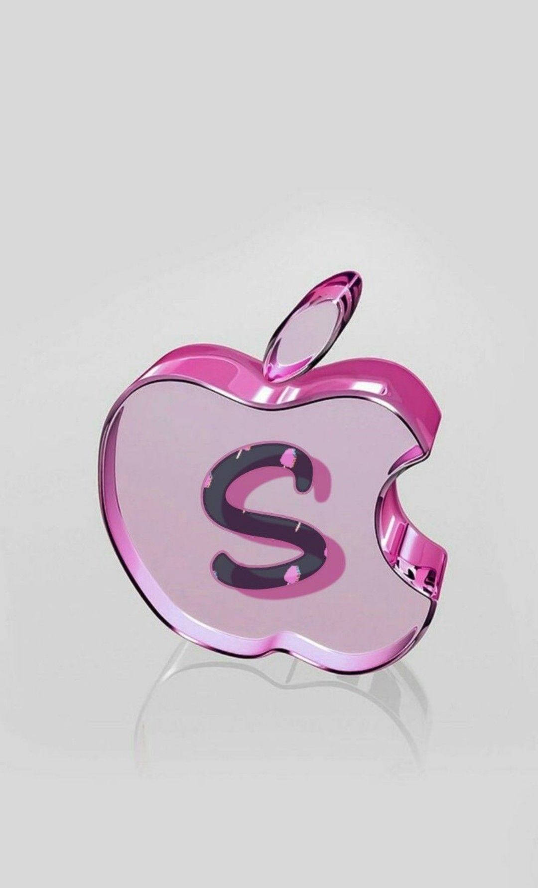 Fruit 桌布 壁紙 — 一個帶有黑色 'S' 的光面粉紅色 Apple 標誌，在灰色中性表面上反射光線。