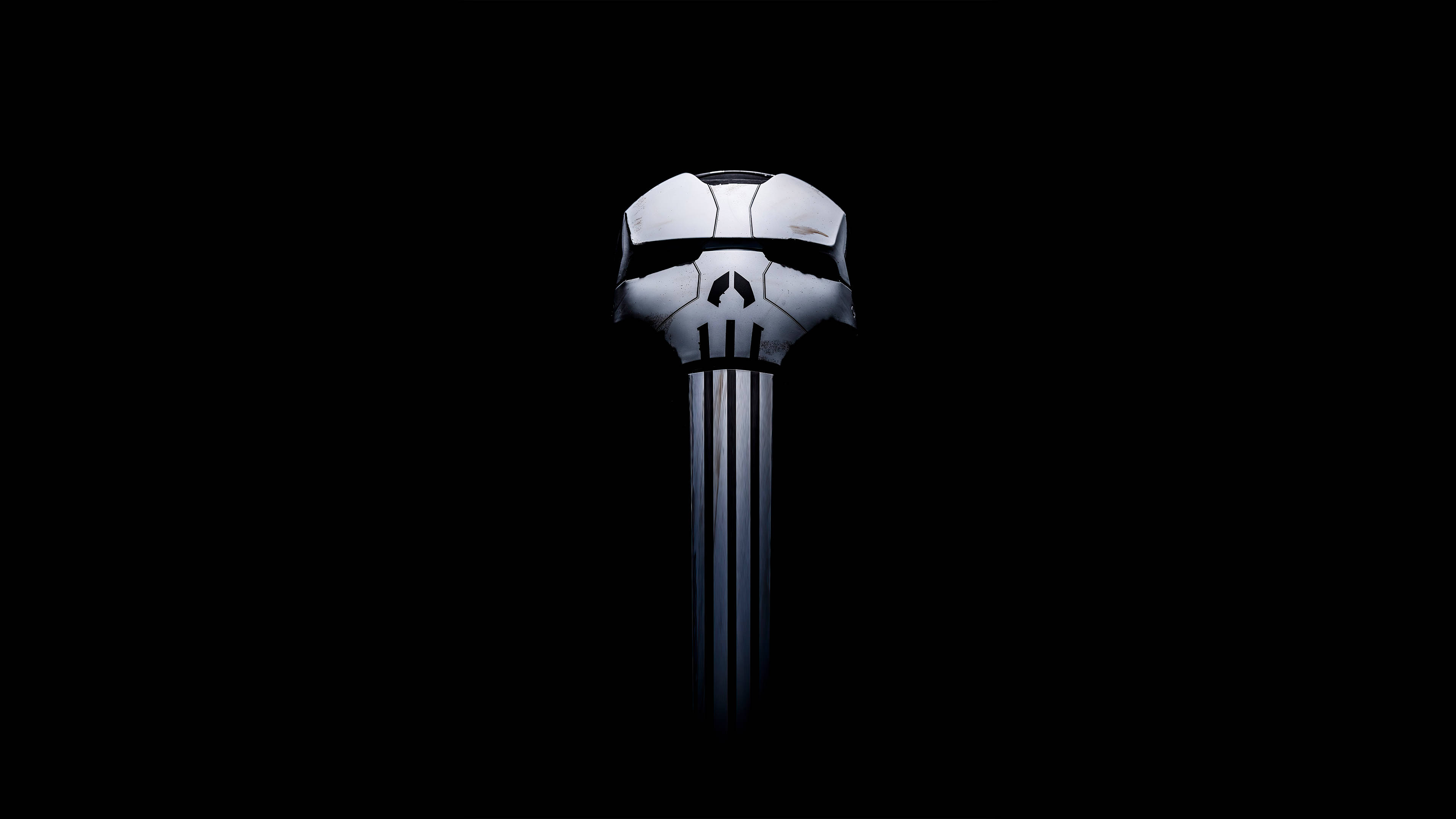 Punisher Logo 桌布 壁紙 — 一個帶有黑色條紋的白色骷髏標誌在純黑色背景上發光。