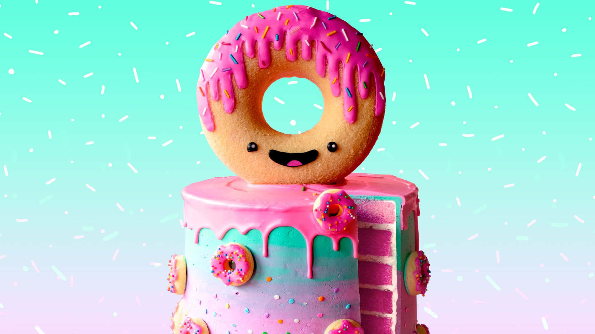 Cute Donut 桌布 壁紙 — 一個帶笑臉的粉紅色糖霜甜甜圈坐在色彩繽紛的層層蛋糕上，蛋糕裝飾著彩色糖粒和小甜甜圈，背景是柔和漸變色。