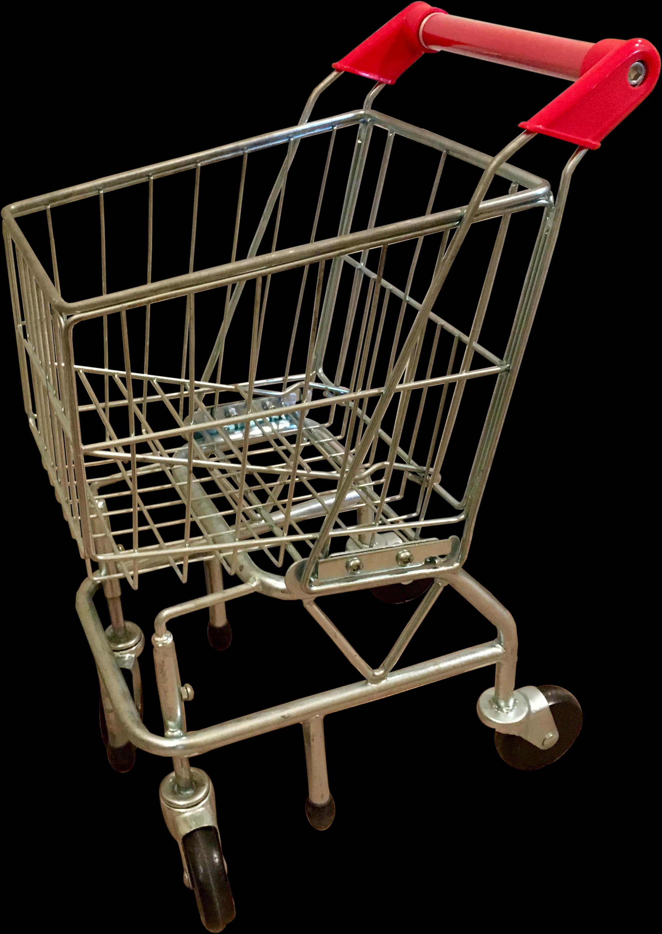 Shopping Cart 桌布 壁紙 — 一個帶紅色手柄的小型空金屬購物車孤立地立在黑色背景上。