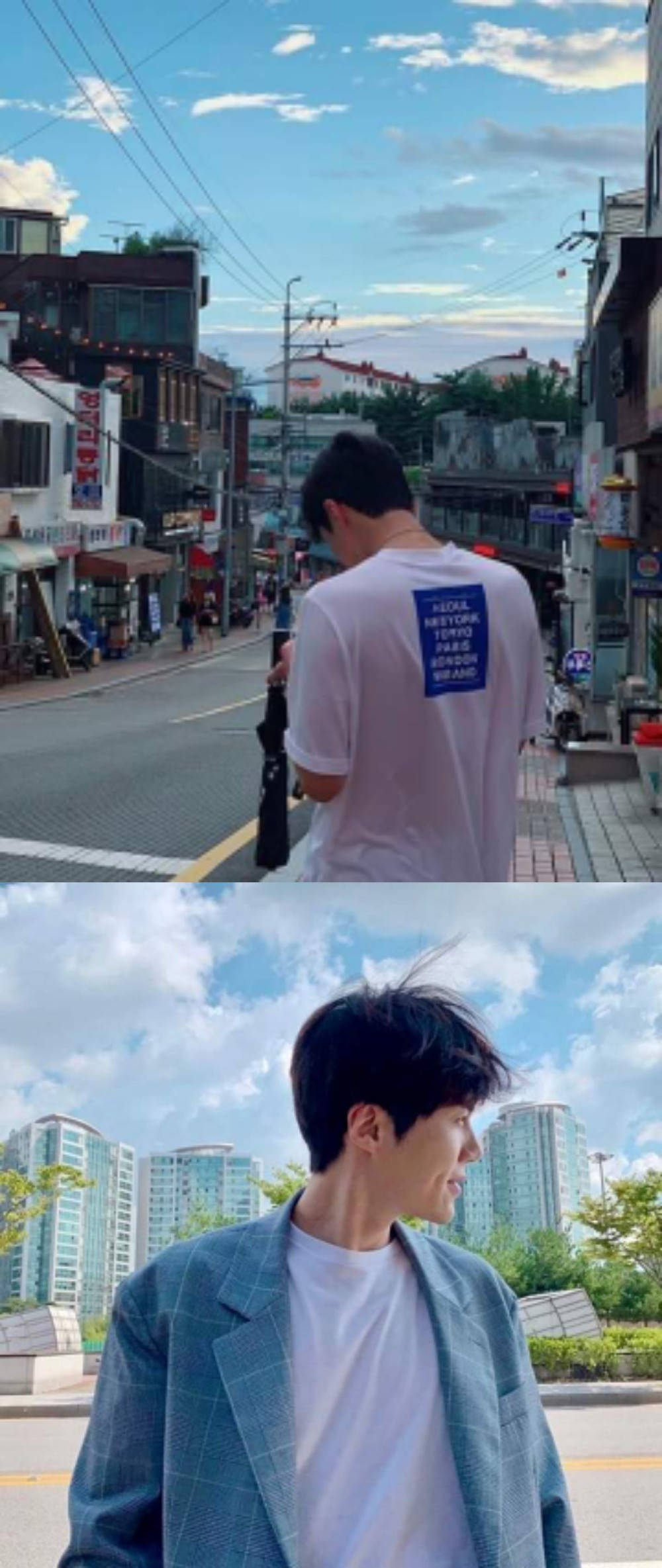 Kim Seon Ho 桌布 壁紙 — 一個年輕男子走在繁華的城市街道上，在明亮的藍天下，以現代高樓大廈為背景微笑站立。