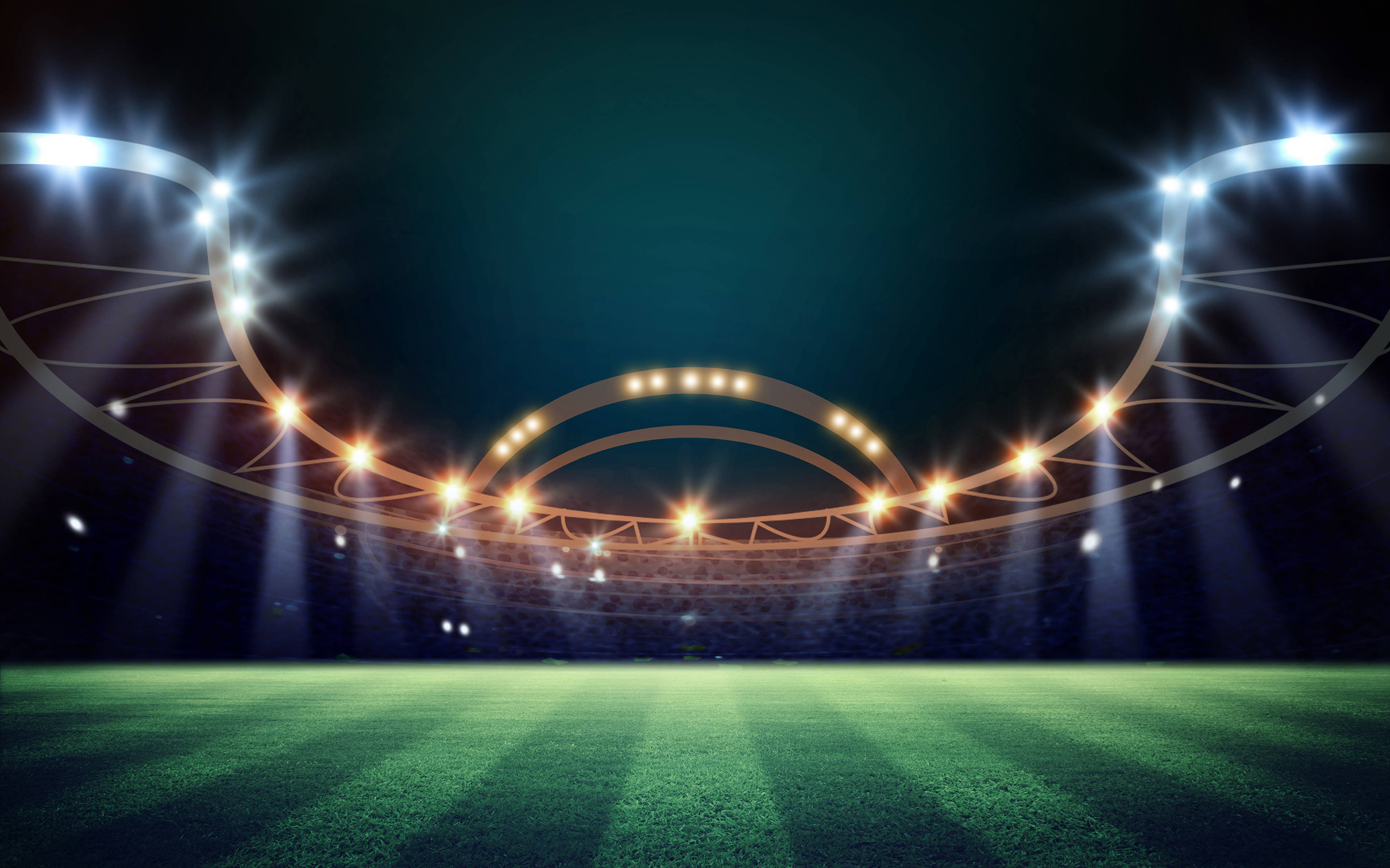 Stadium 桌布 壁紙 — 一個廣闊的綠色足球場，被明亮的體育場燈光照亮，映襯著黑暗的夜空。