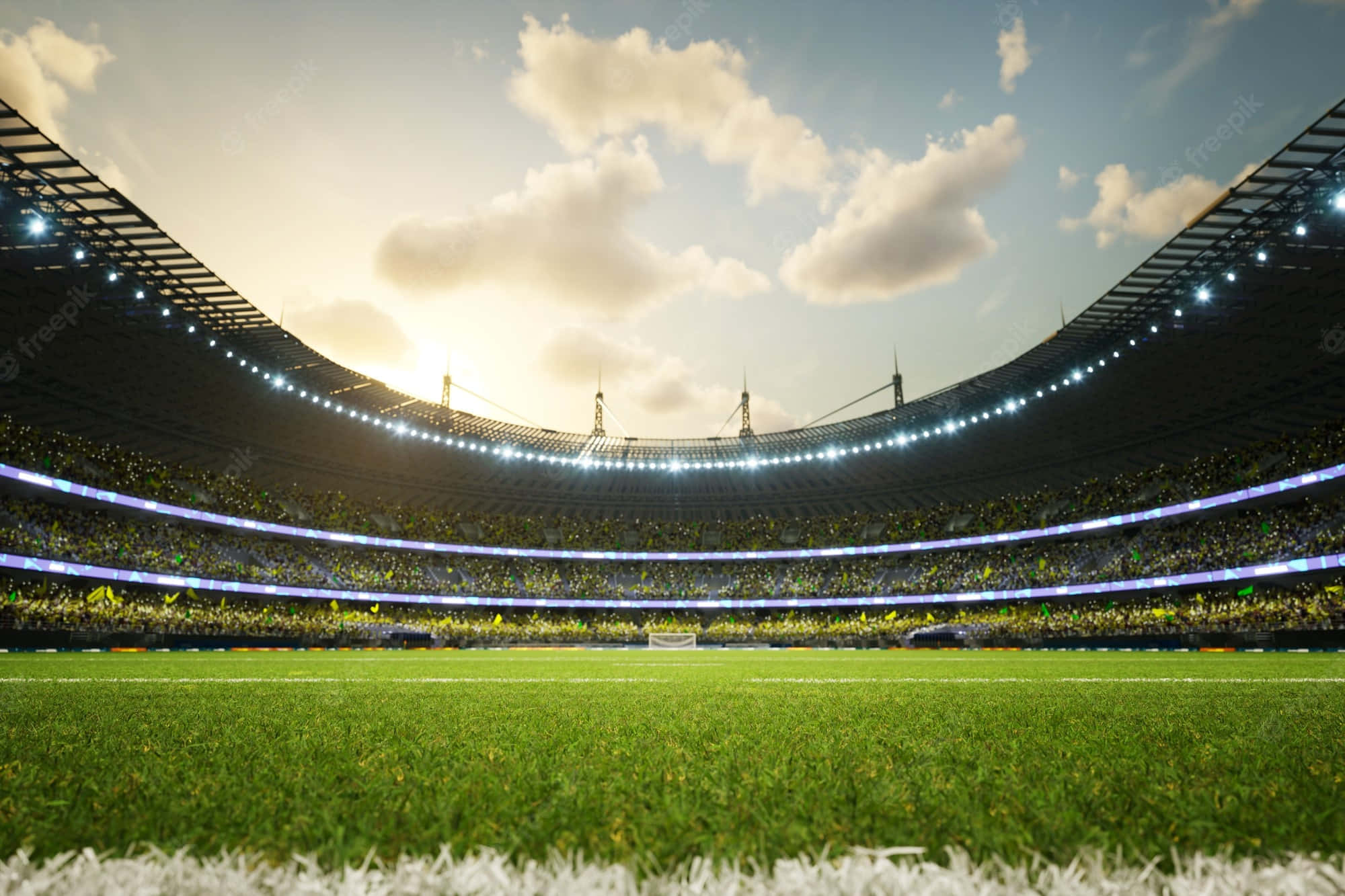 Soccer Stadium 桌布 壁紙 — 一個廣闊的足球場，充滿了在晴朗天空下歡呼的球迷，天空中有散落的雲朵。