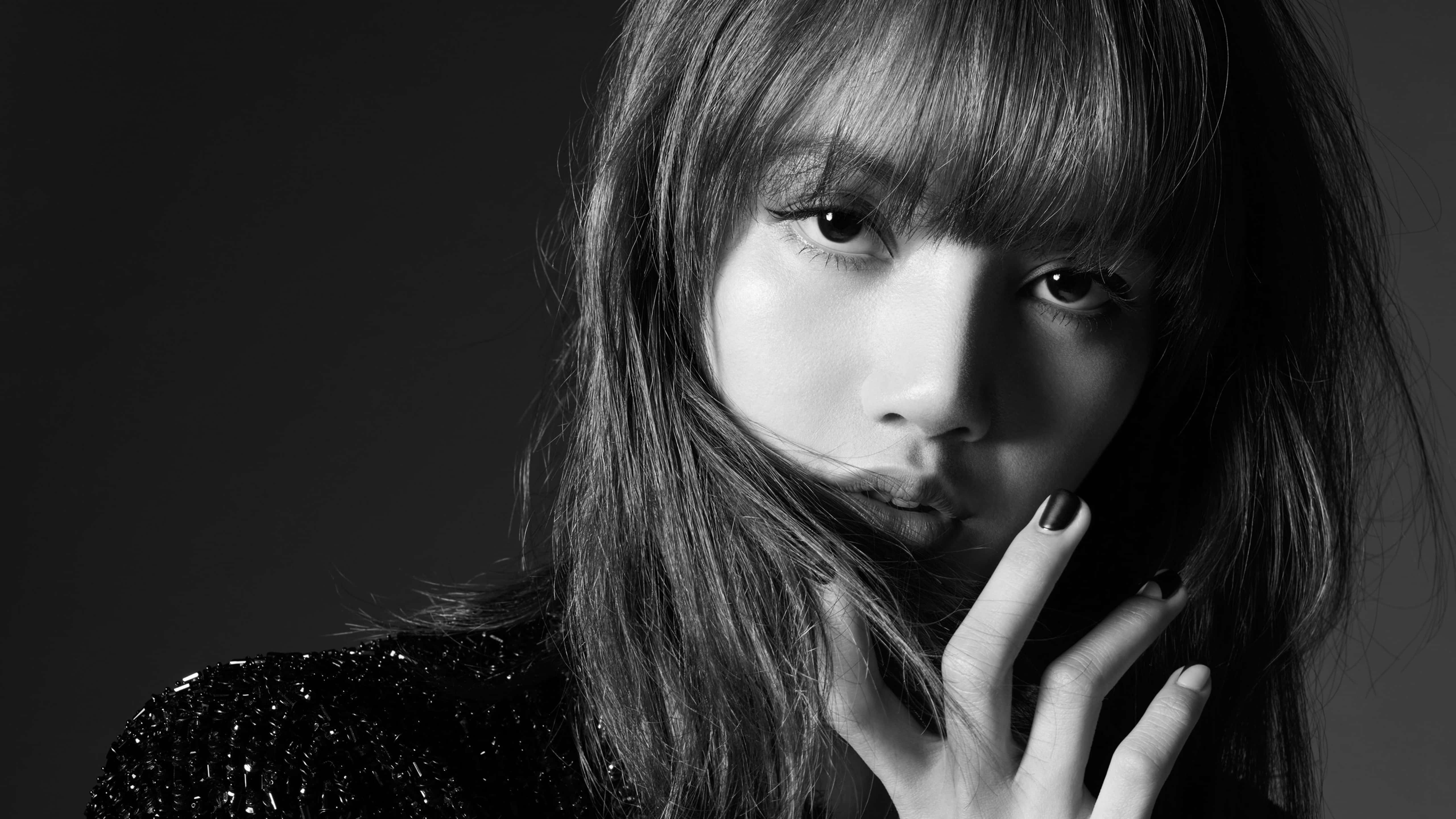 BLACKPINK 桌布 壁紙 — 一個引人注目的黑白肖像，一位留有瀏海和深色指甲油的女性，凝視著鏡頭。