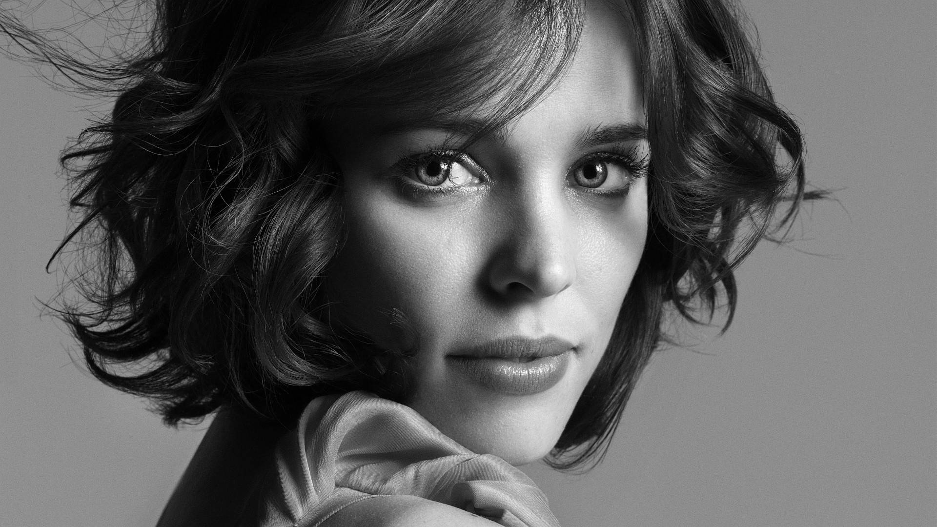 Rachel Mcadams 桌布 壁紙 — 一個引人注目的黑白肖像，捕捉一位頭髮被風吹亂的女子，專注地凝視著鏡頭。