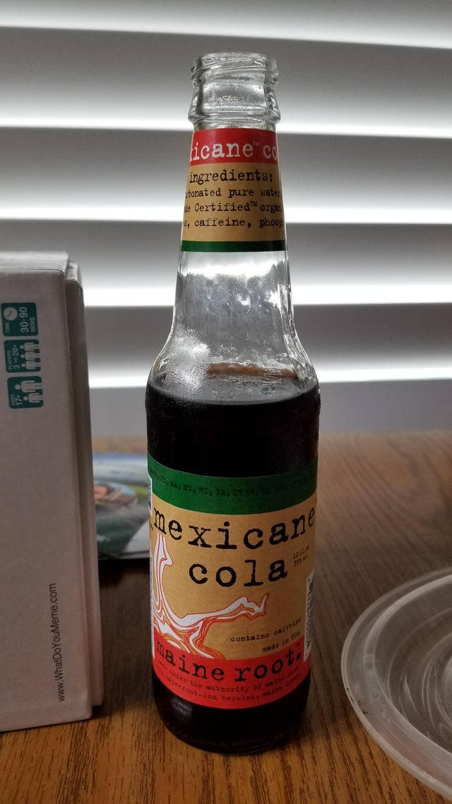 Mexican 桌布 壁紙 — 一個復古風格的墨西哥可樂玻璃瓶，帶有醒目的標籤，放在木桌上，旁邊有一個紙板箱和塑料蓋。