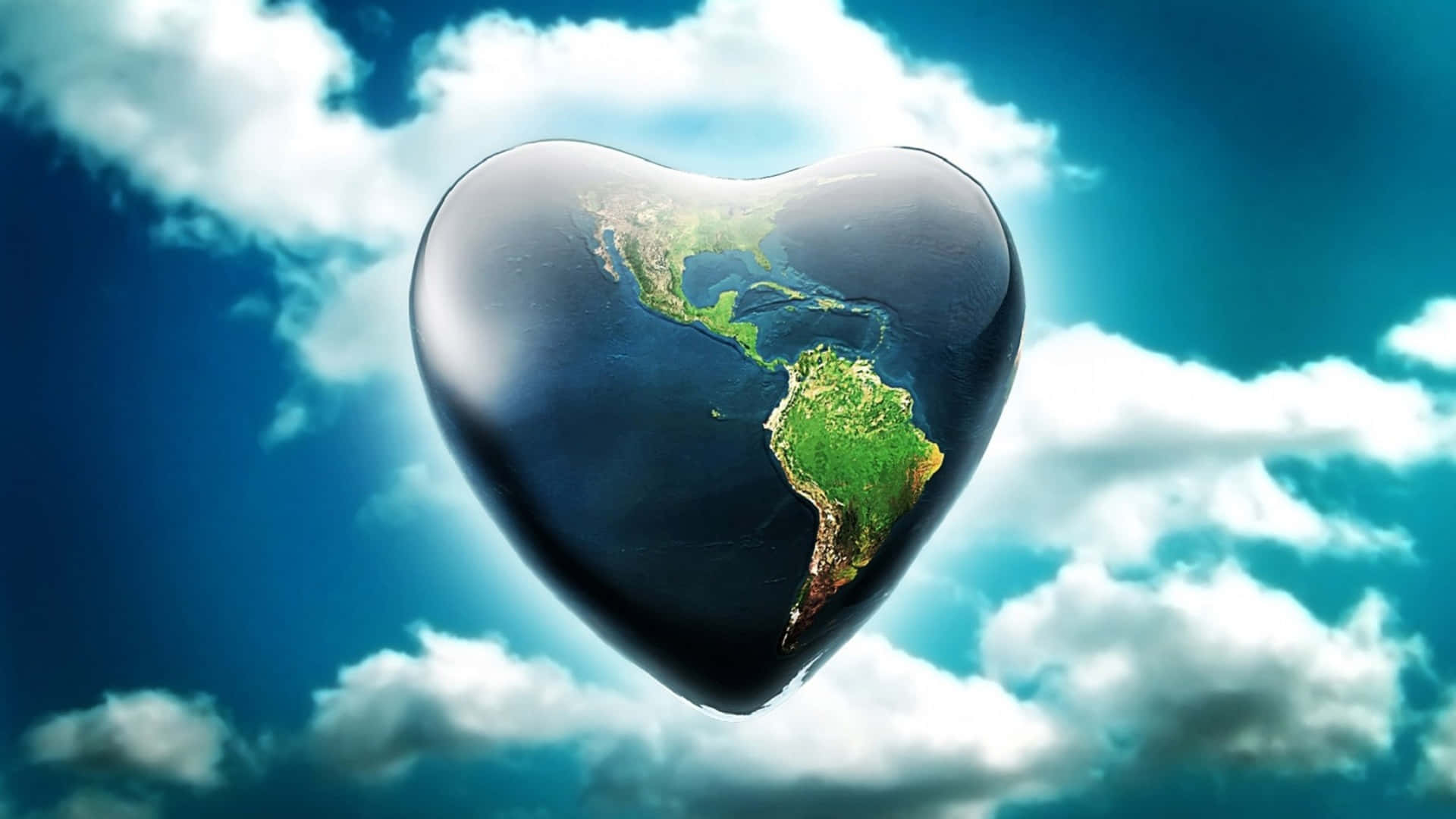 3d Earth 桌布 壁紙 — 一個心形地球，可見美洲，漂浮在充滿蓬鬆白雲的鮮豔藍天上。
