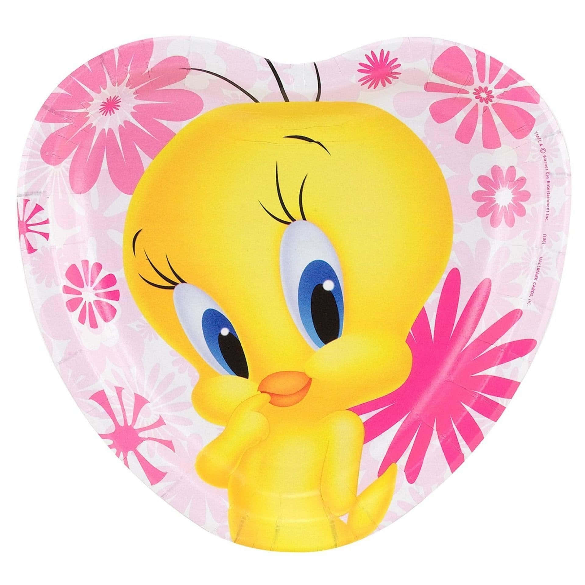 Tweety Bird 桌布 壁紙 — 一個心形紙盤上有一隻快樂的黃色卡通鳥，藍色眼睛，周圍環繞著粉紅色花卉圖案。