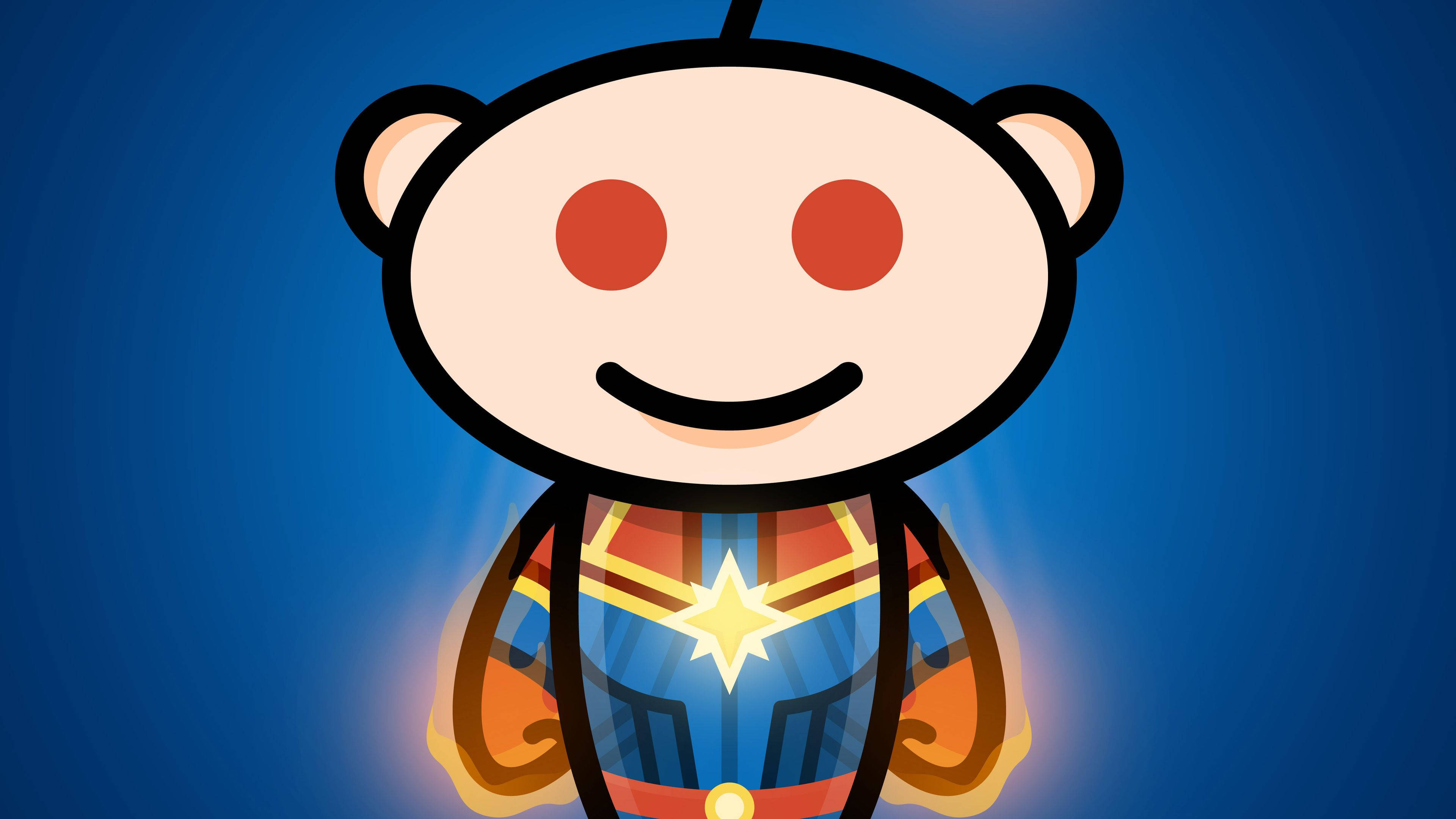 reddit 桌布 壁紙 — 一個快樂的卡通外星人吉祥物，穿著超級英雄服裝，帶有發光的星星標誌，背景為藍色漸變。