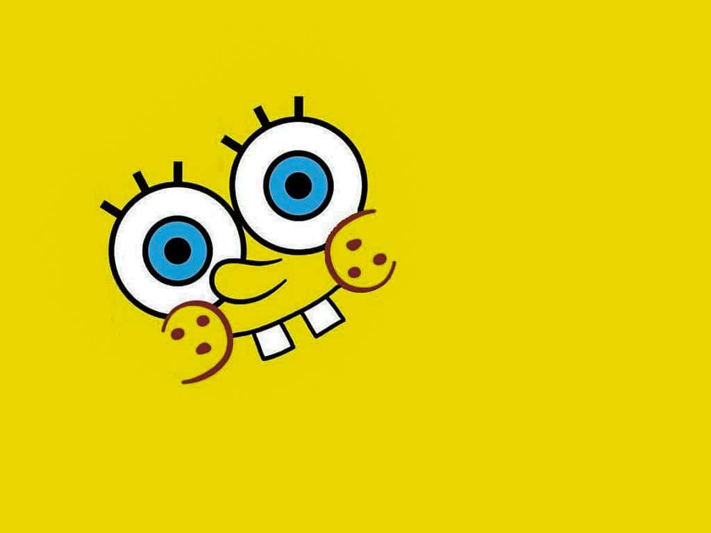 Spongebob Supreme 桌布 壁紙 — 一個快樂的卡通海綿，有著大大的藍眼睛和餅乾手，從純黃色背景中頑皮地探出頭來。