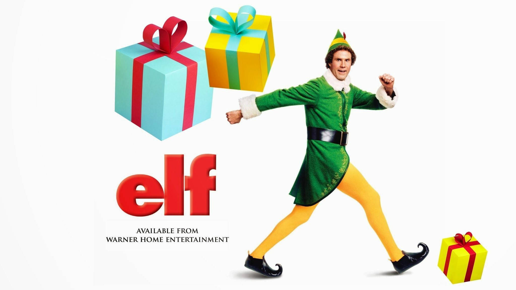 Elf Movie 桌布 壁紙 — 一個快樂的男人穿著綠色精靈服裝，在純白色背景上與漂浮的彩色禮物盒一起充滿活力地跳舞。