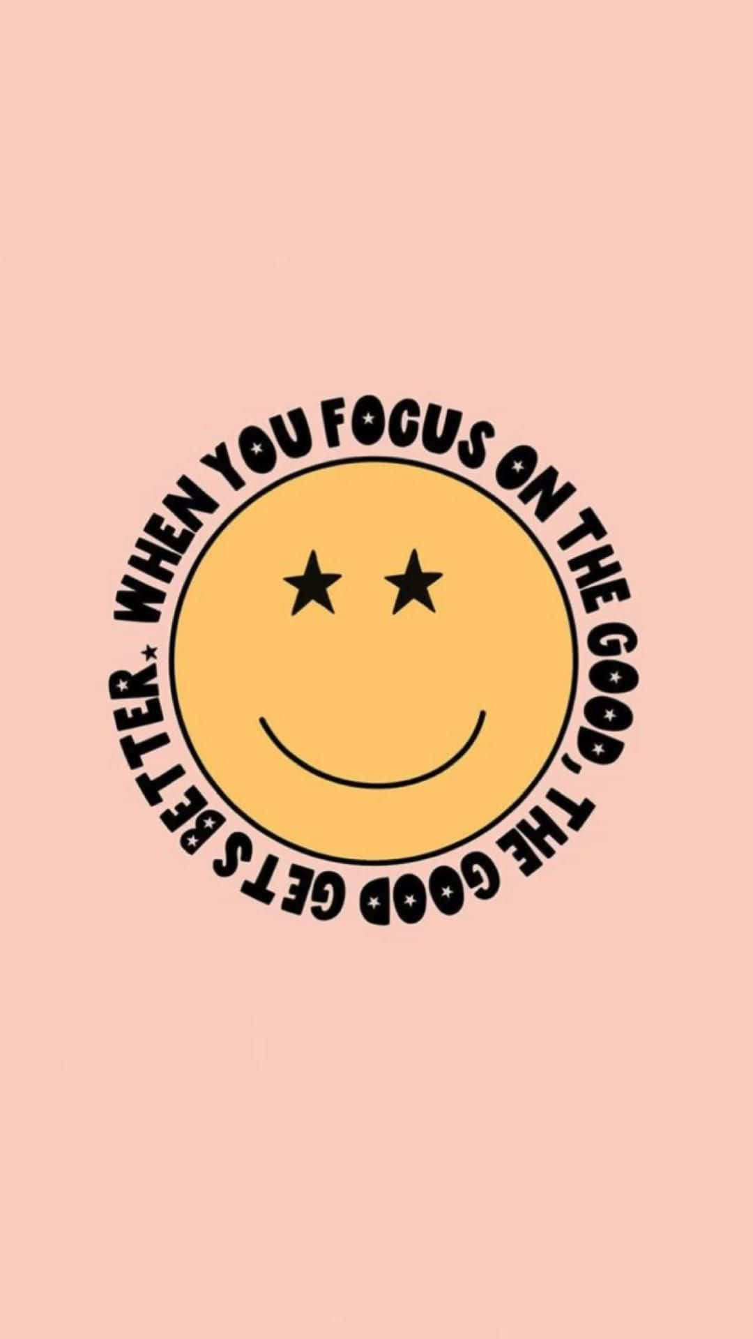 Vsco 桌布 壁紙 — 一個快樂的黃色笑臉，帶有星星眼睛和勵志文字，在柔和的桃色背景上。