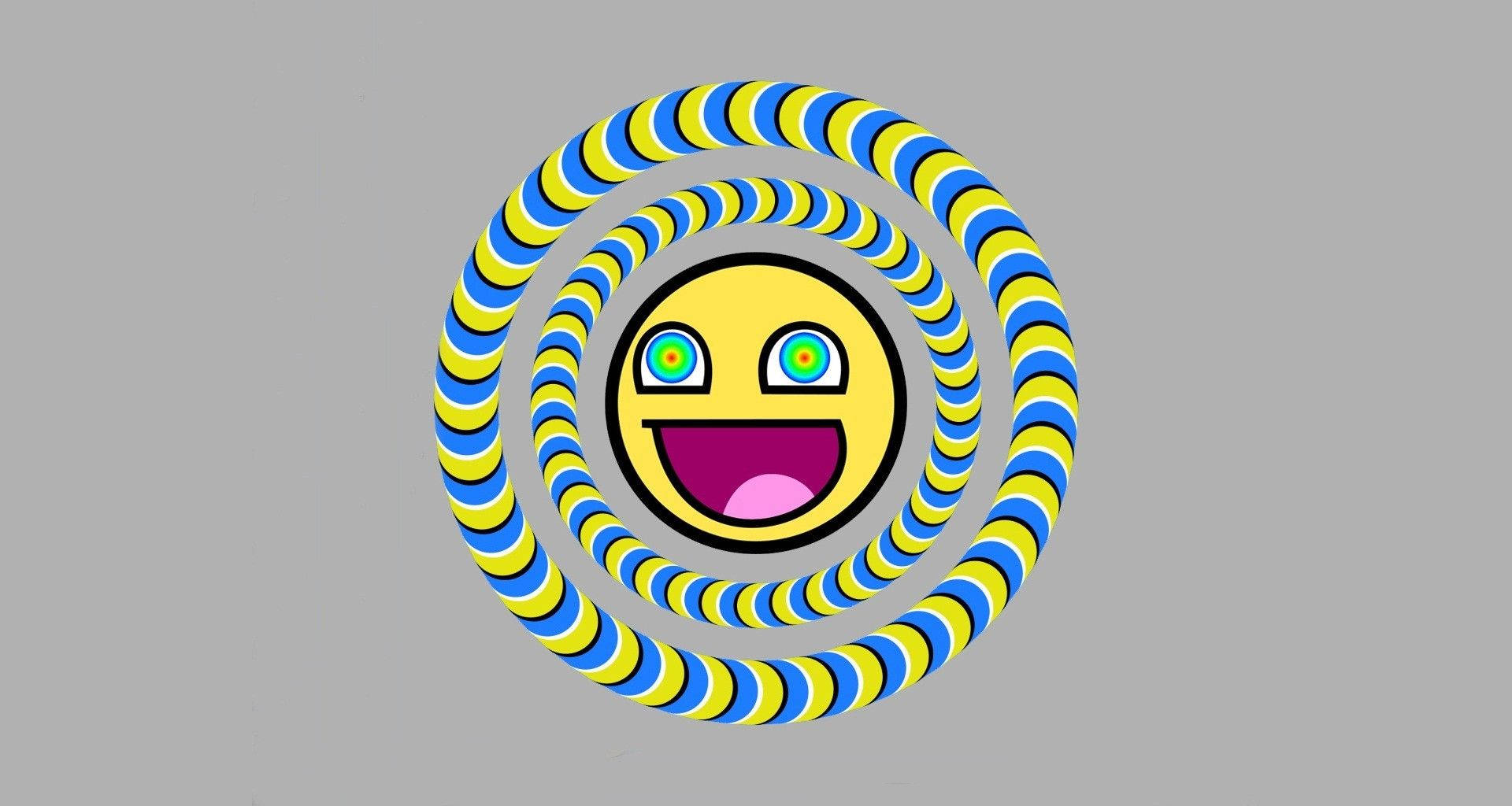 meme 桌布 壁紙 — 一個快樂的黃色笑臉，綠色眼睛，位於灰色背景上藍色和黃色條紋的催眠螺旋中心。