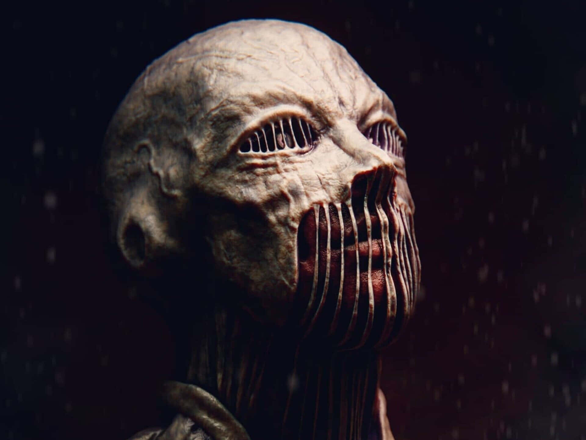 War Hammer Titan 桌布 壁紙 — 一個怪誕的人形頭部，帶有棱紋的面部特徵和張開的嘴巴，在黑暗的雨景背景下強烈凝視。
