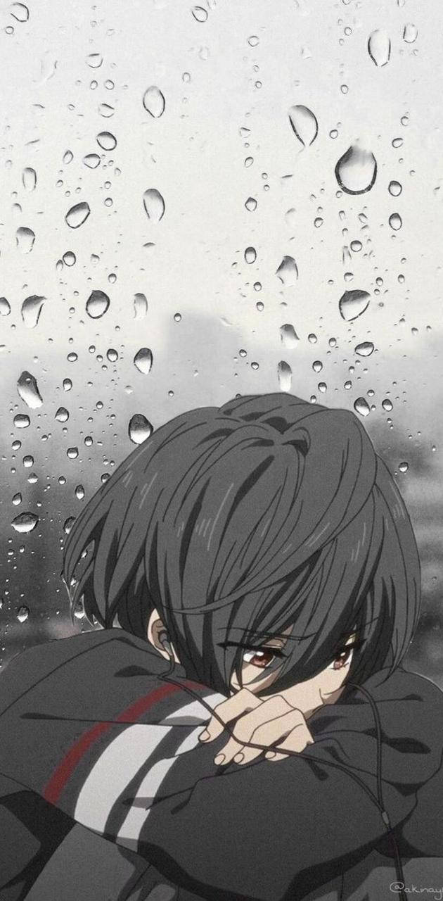 動漫男孩在雨窗前抱著膝蓋，神情沮喪