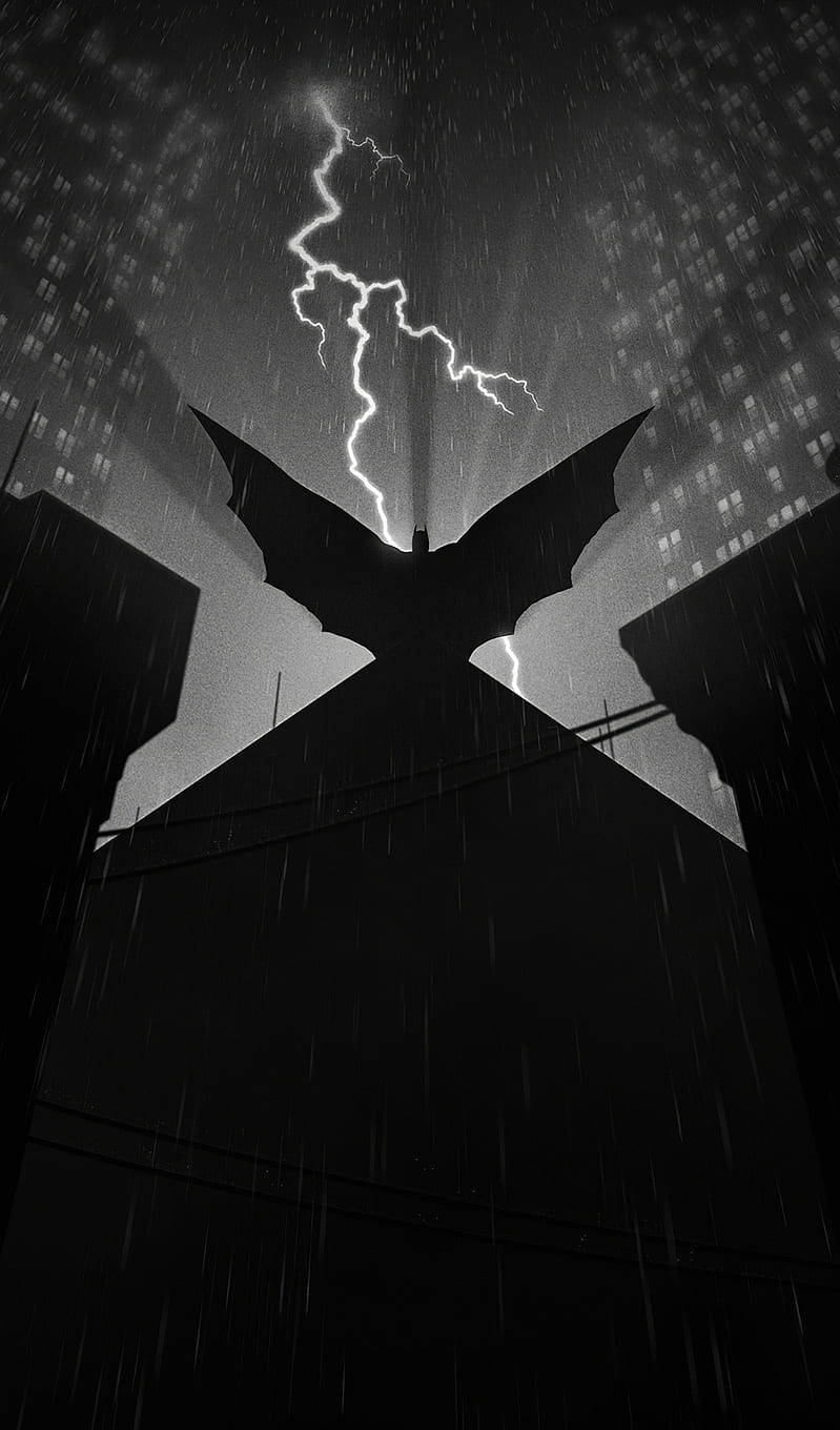 Animated 桌布 壁紙 — 一個戲劇性的黑白剪影，蝙蝠形狀的結構在暴風雨的城市天際線背景下，閃電在頭頂劃過。